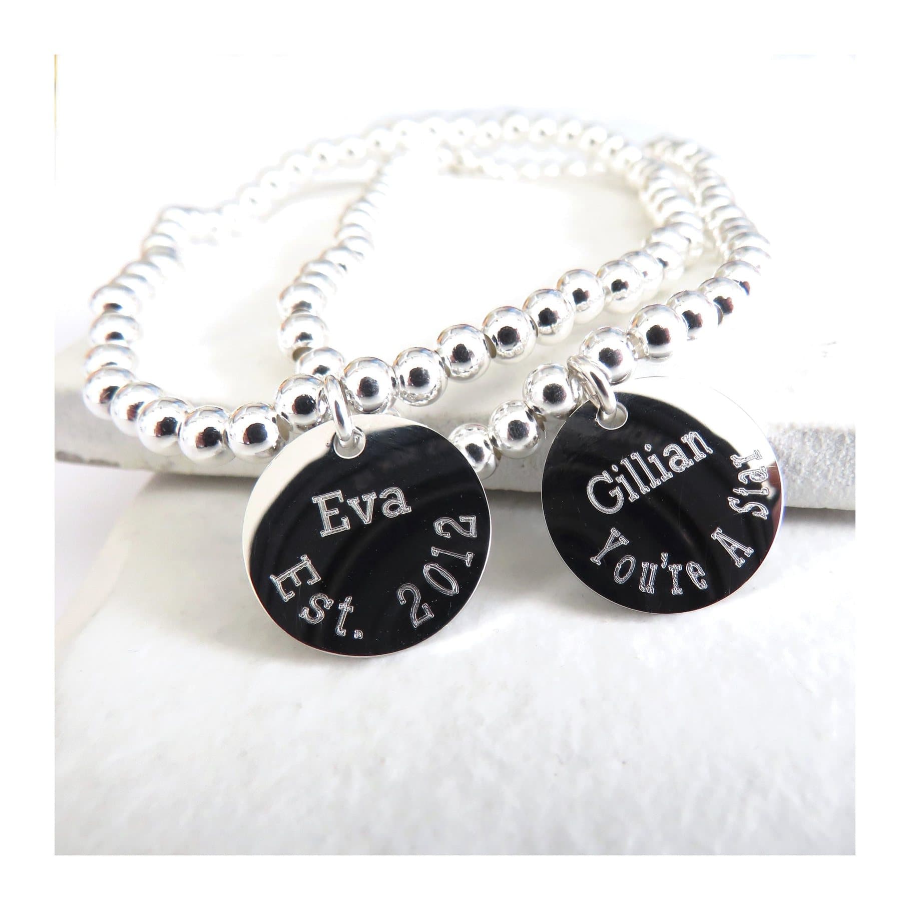 Personalised silver beaded charm bracelet with a round silver coloured charm