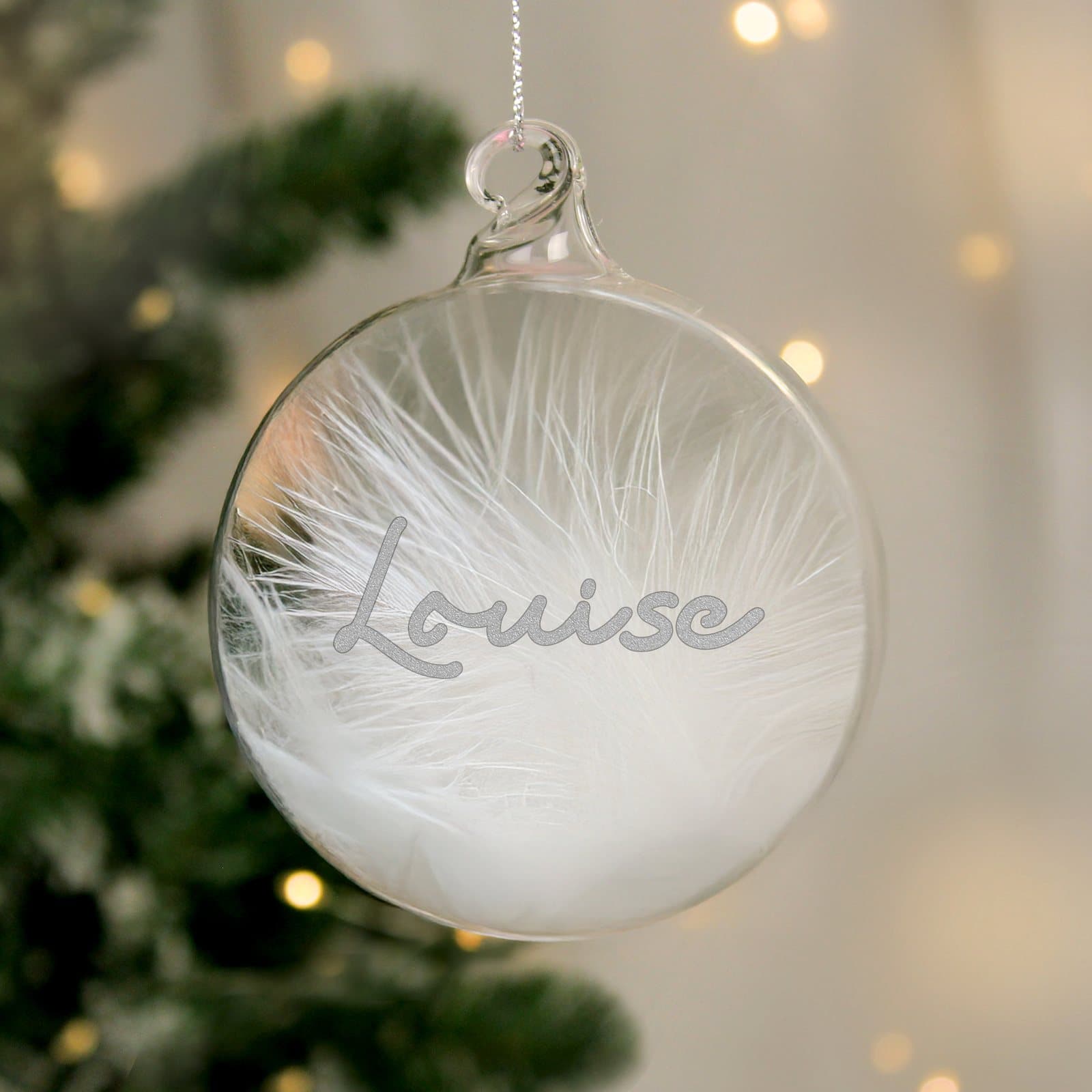 Silver glitter glass bauble filled with a white feather