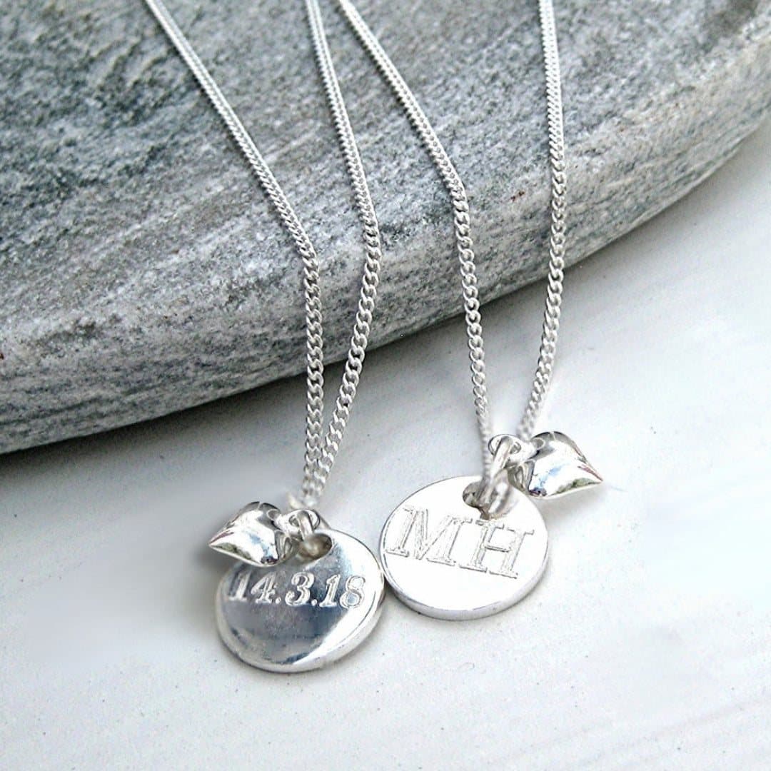 Silver mini disc necklace with a heart charm on a fine chain