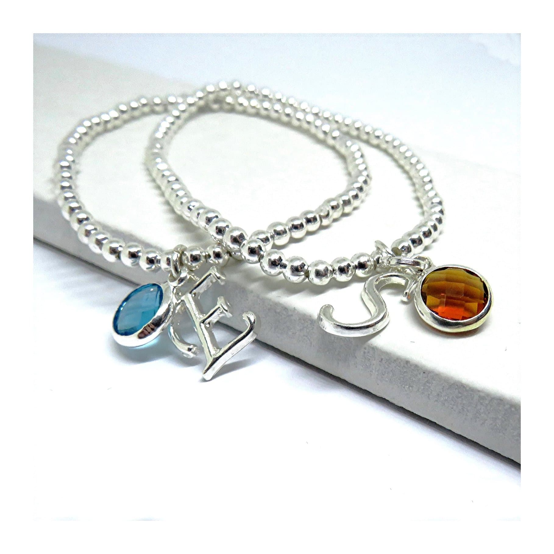 Silver stretch bracelet with a coloured birthstone and an initial