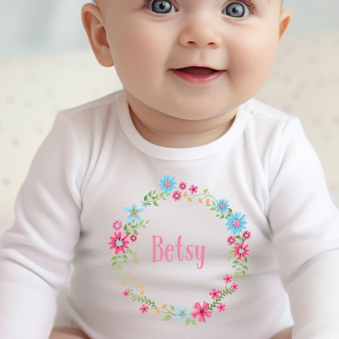 Personalised floral circle baby grow, vest or bib with a name added to the design