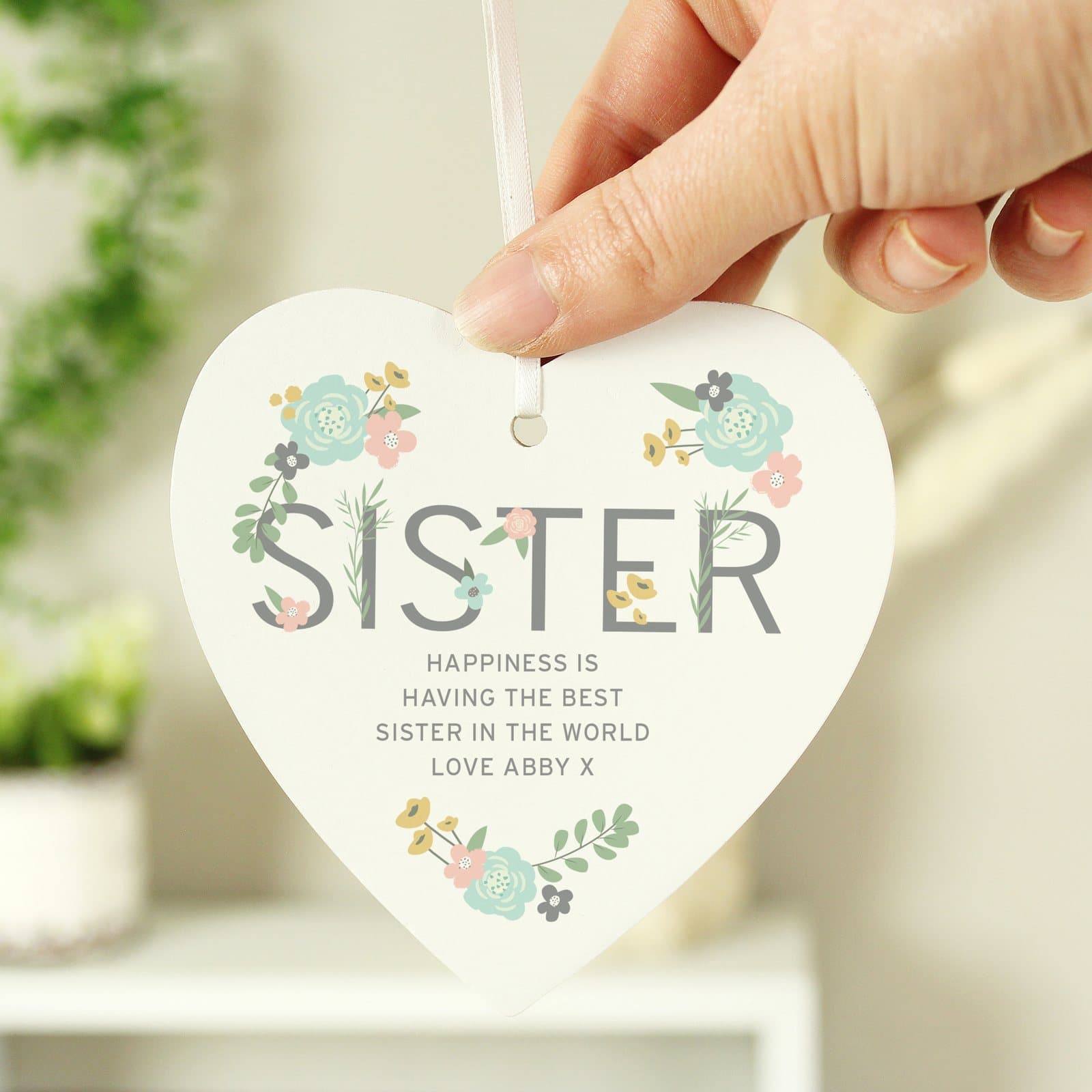Wooden heart decoration with a floral Sister design and ribbon