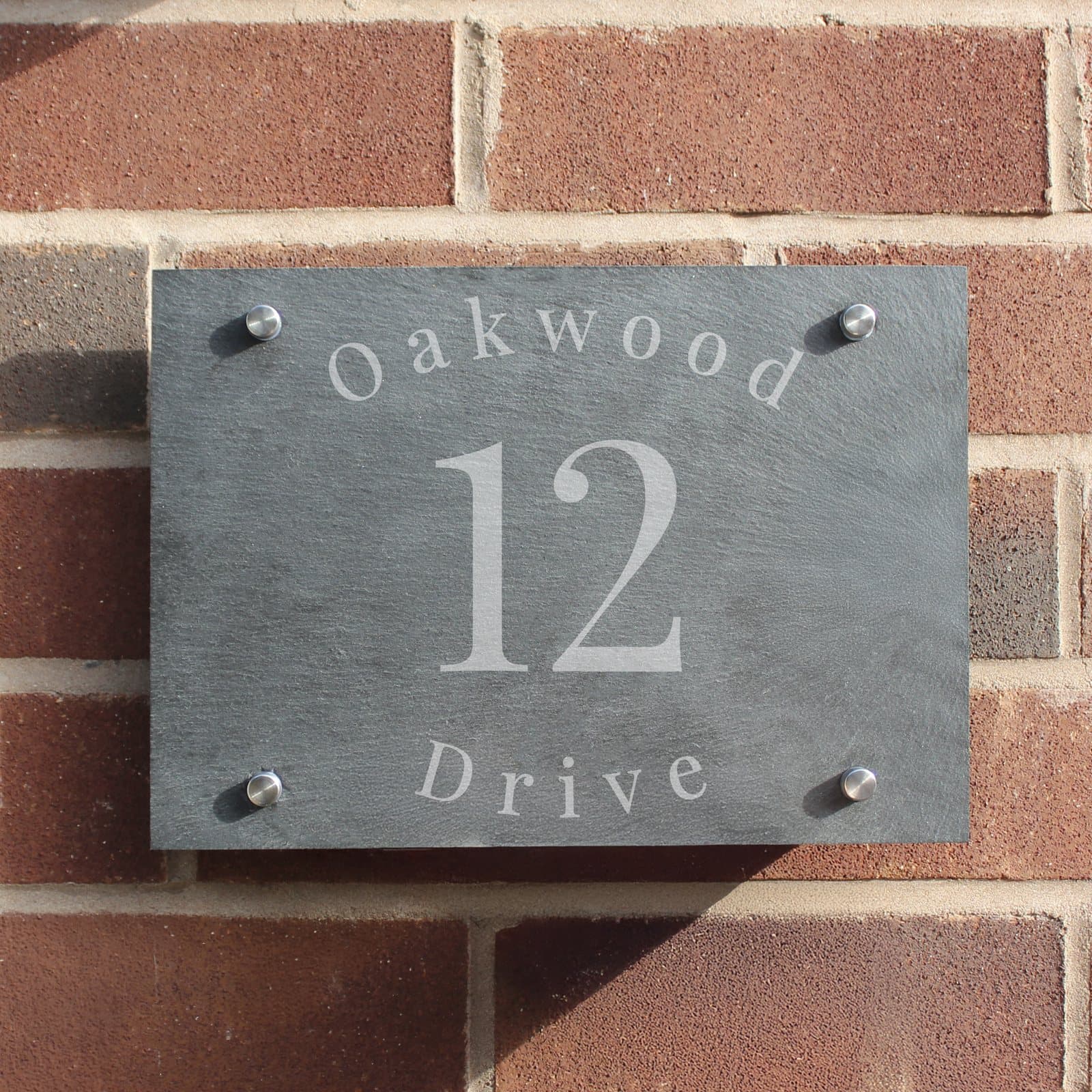 Slate house sign with a house number and two lines of text