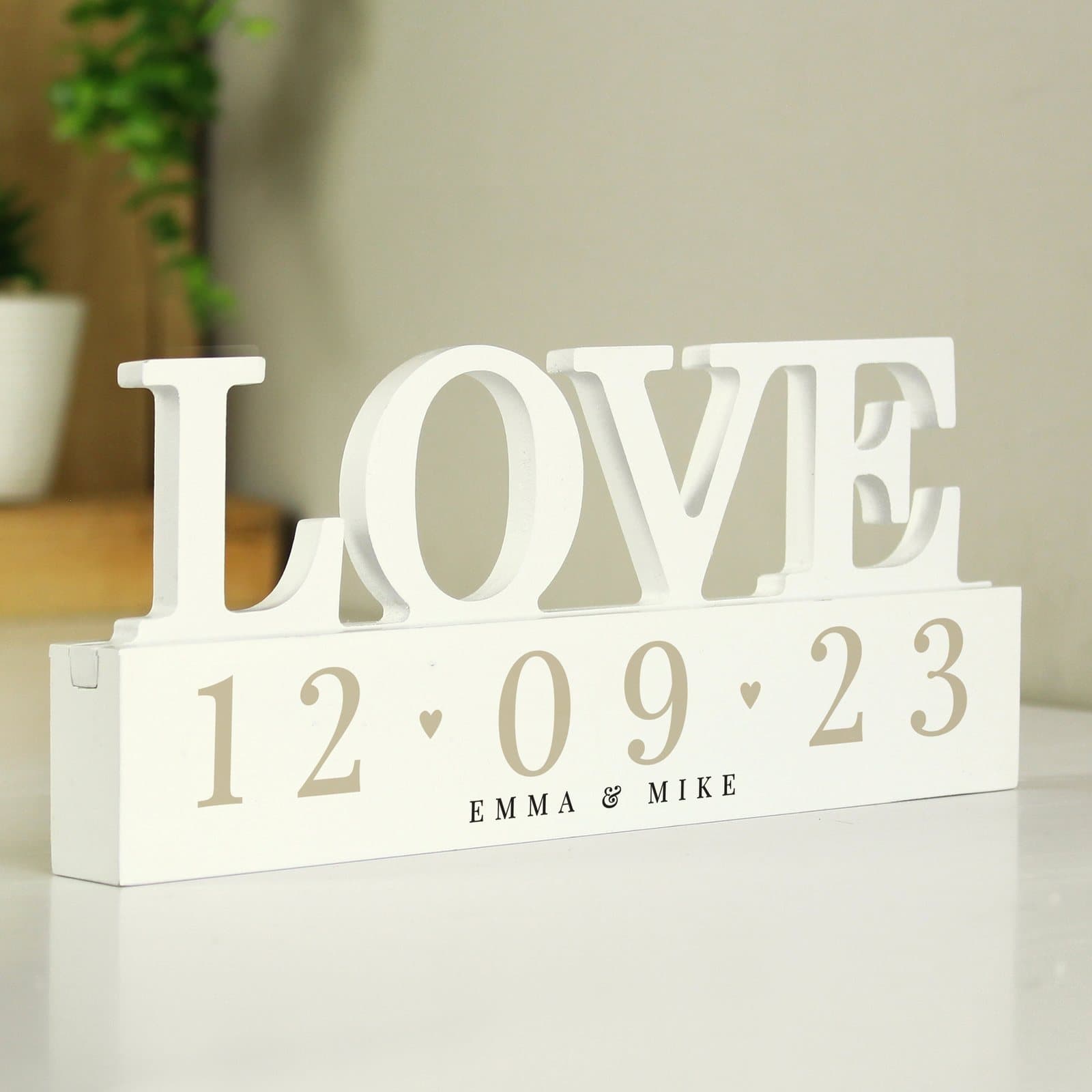 Handmade wooden love ornament with a personalised date and message
