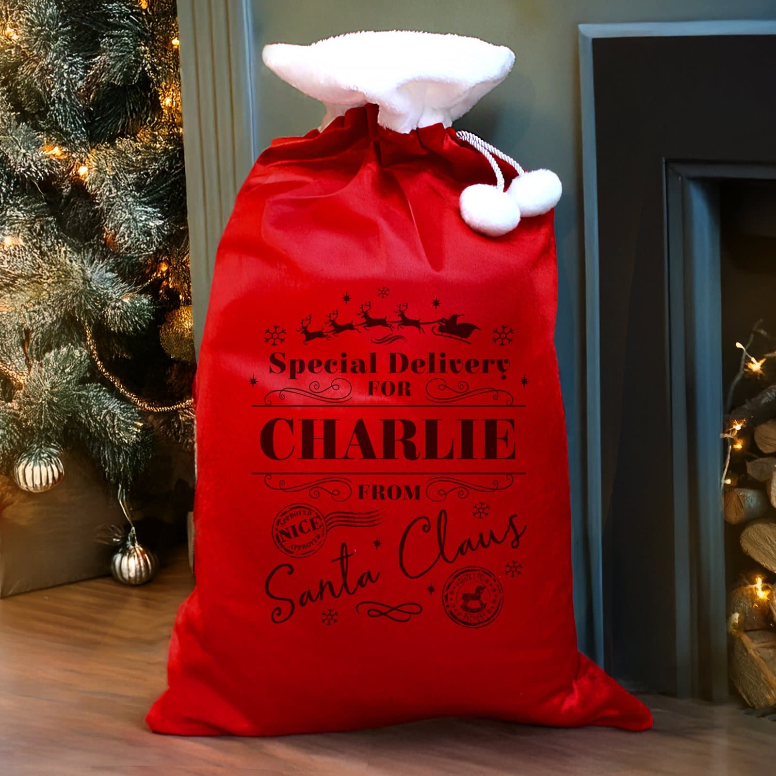 Red fleece pom pom sack with Santa wording and From Santa Claus text