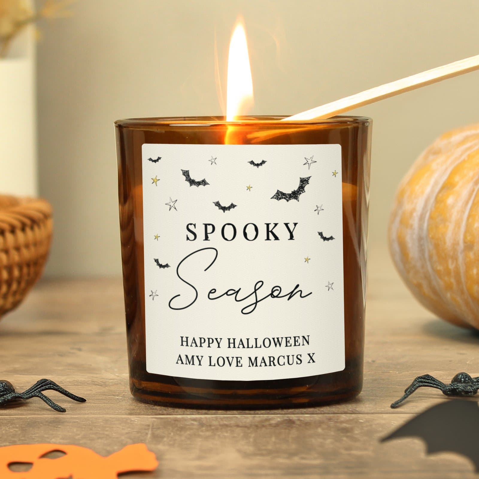 Amber glass candle jar with a Spooky Season label and message