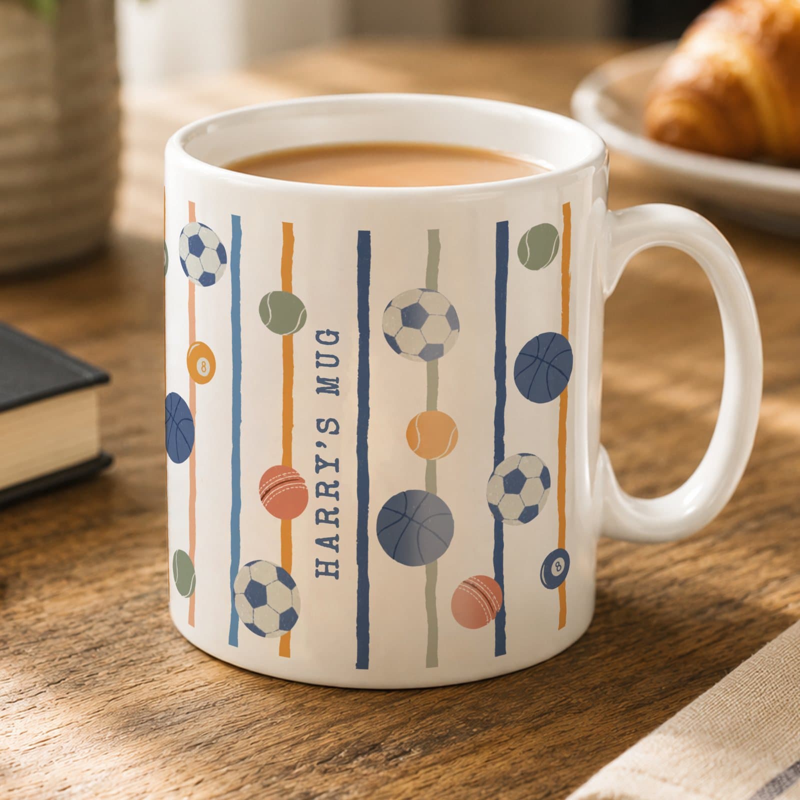 Personalised ceramic mug with a sports ball design wrapped around it
