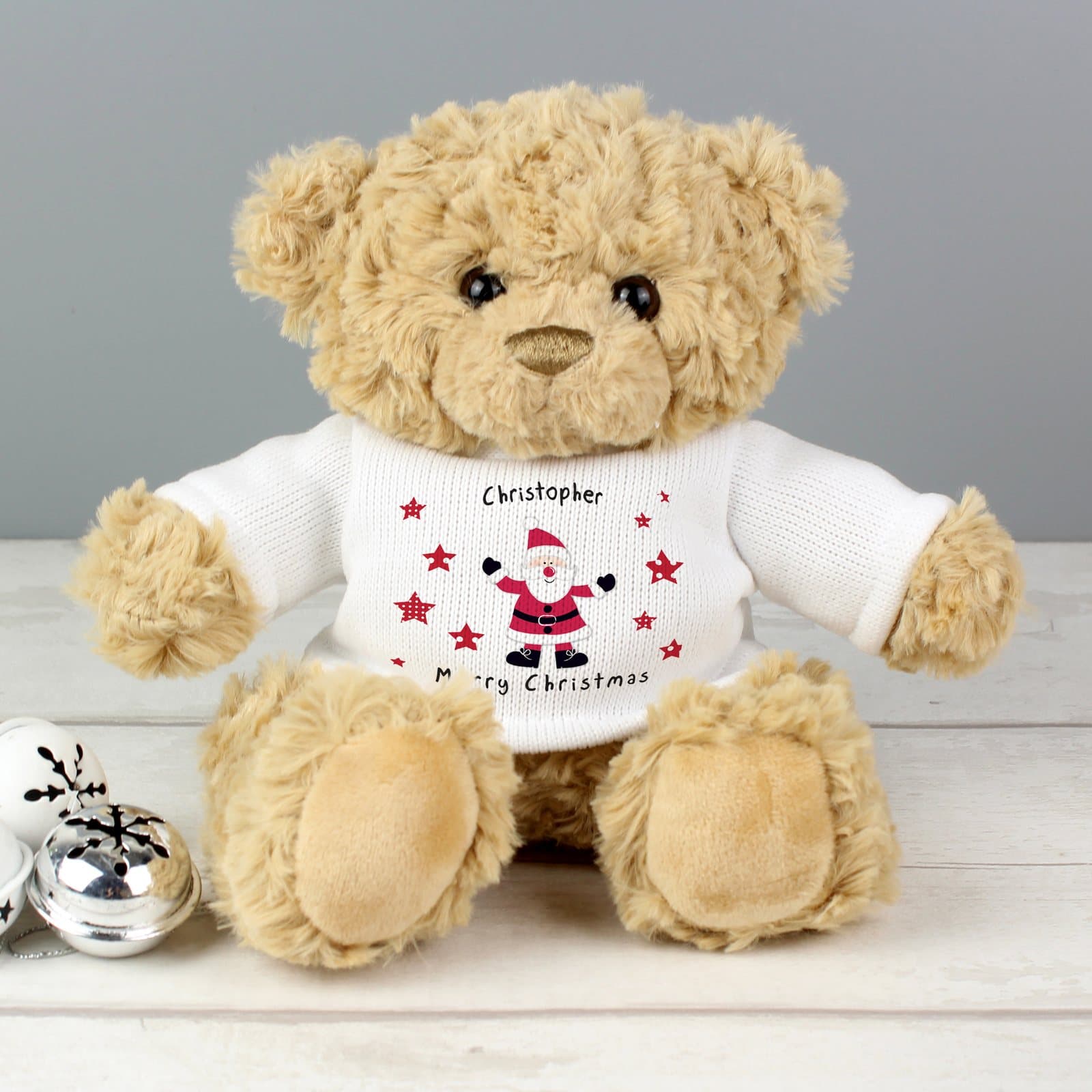 Cuddly teddy bear in a spotty Santa T-shirt