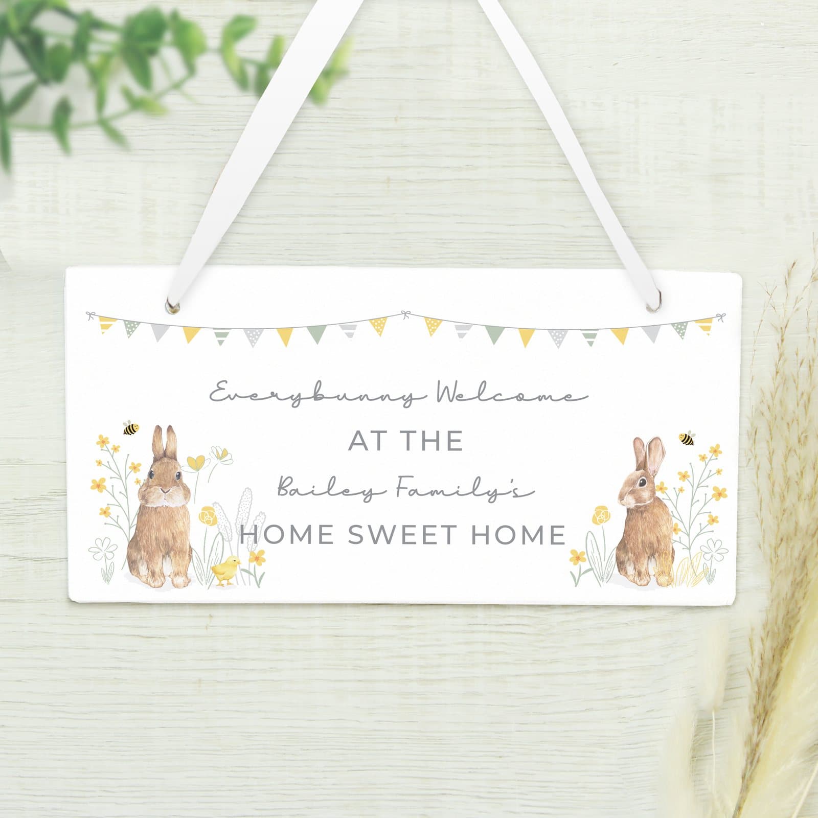 Wooden sign with a spring bunny design and ribbon
