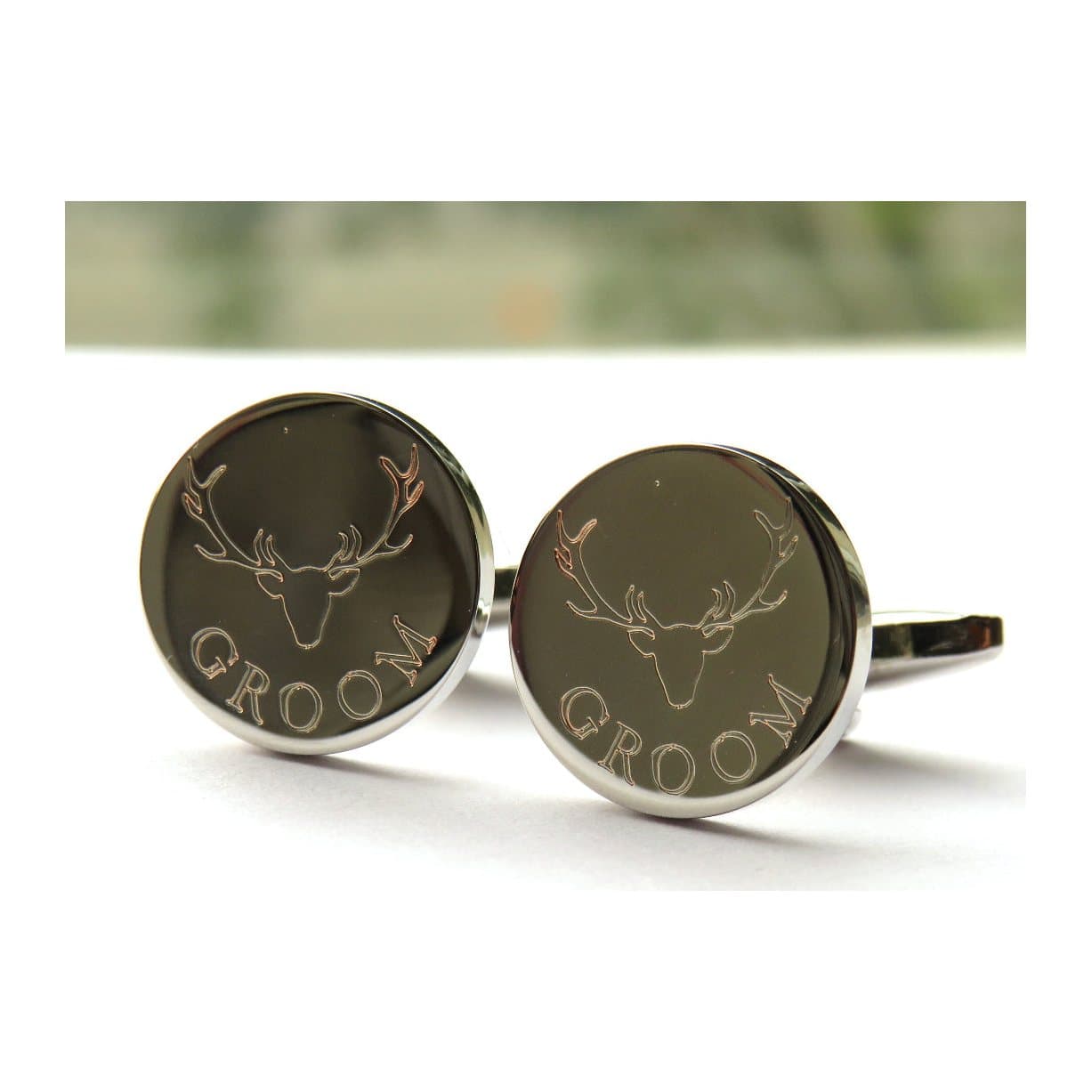 Round silver cufflinks with a stag's head design