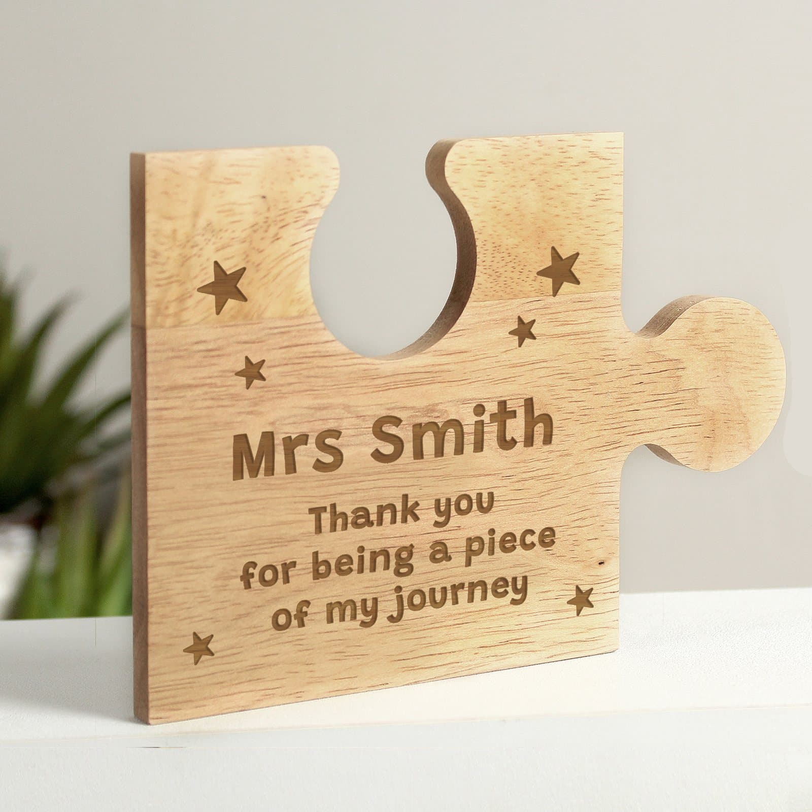 Wooden jigsaw piece with a star design and personalised text