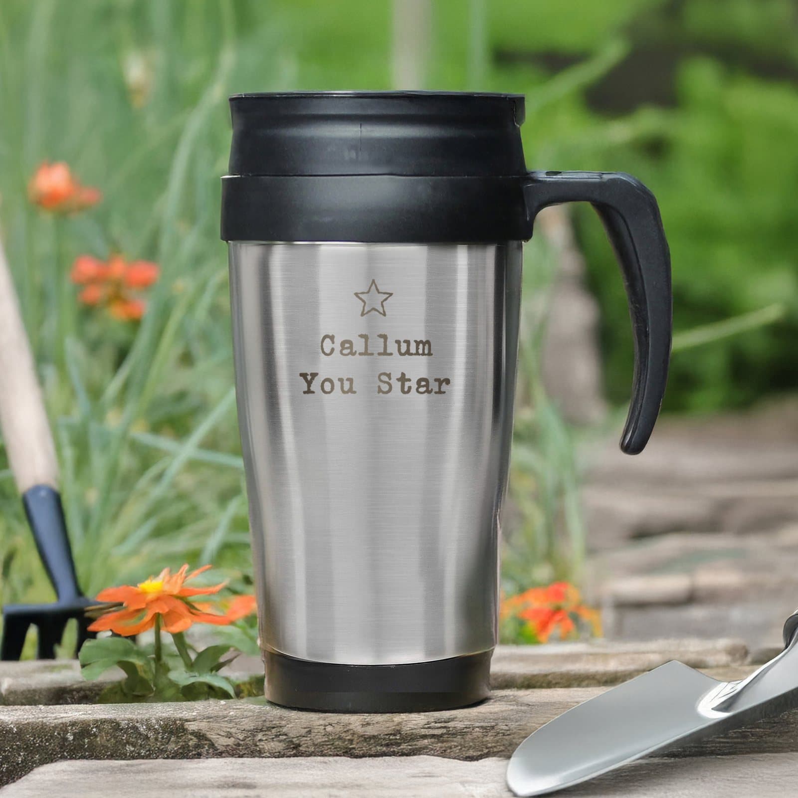 Stainless steel travel mug with star motif and plastic handle