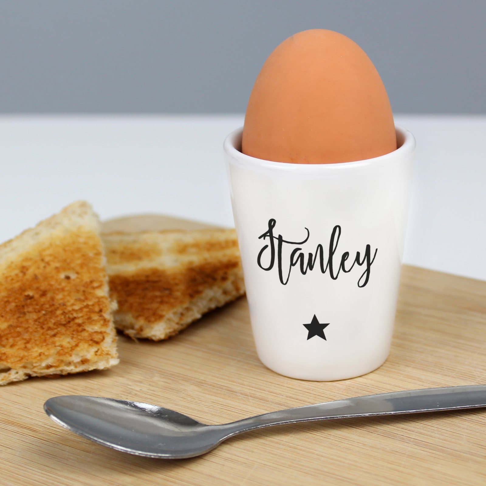 Personalised star ceramic egg cup with a name