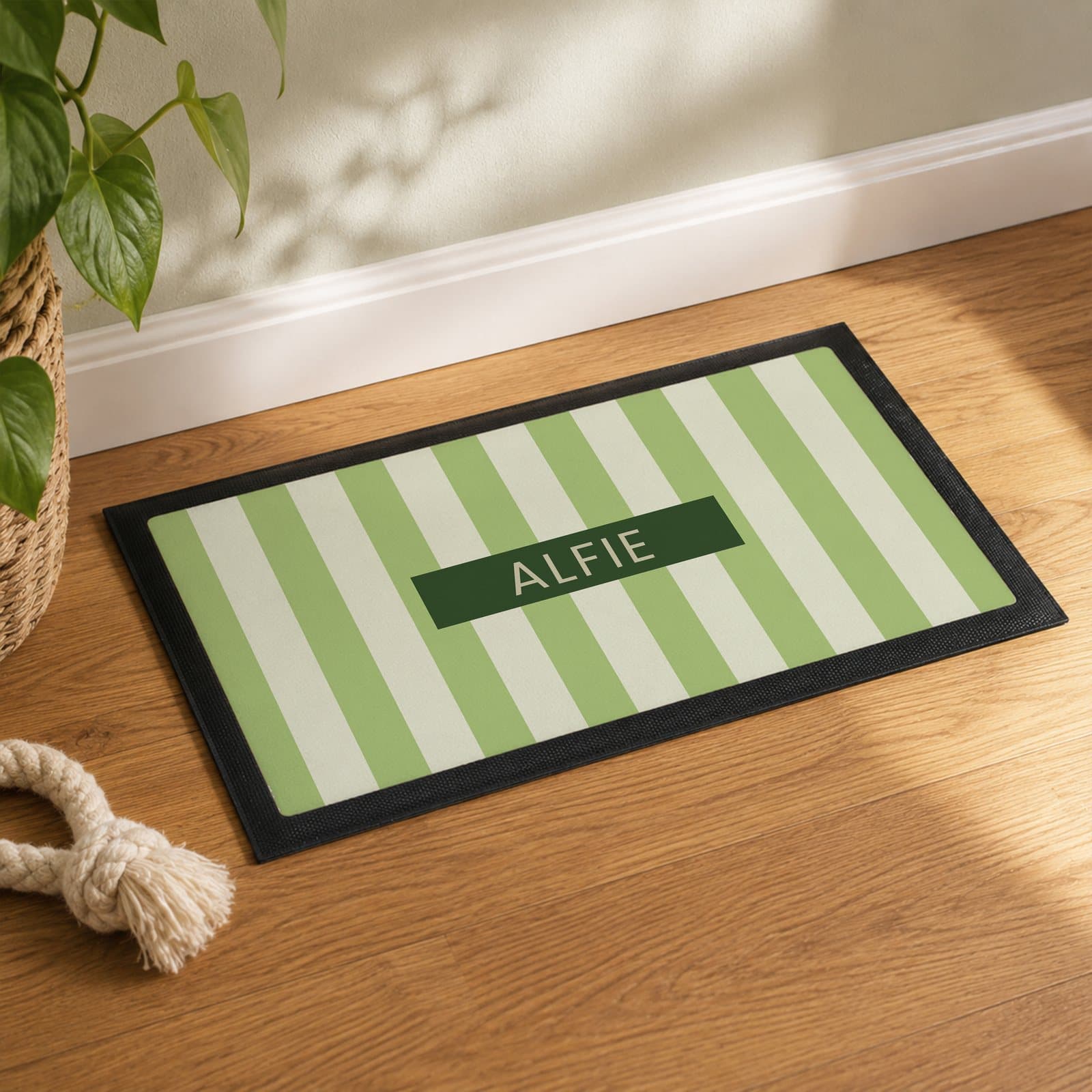 Striped pet bowl mat with a pet's name in capitals