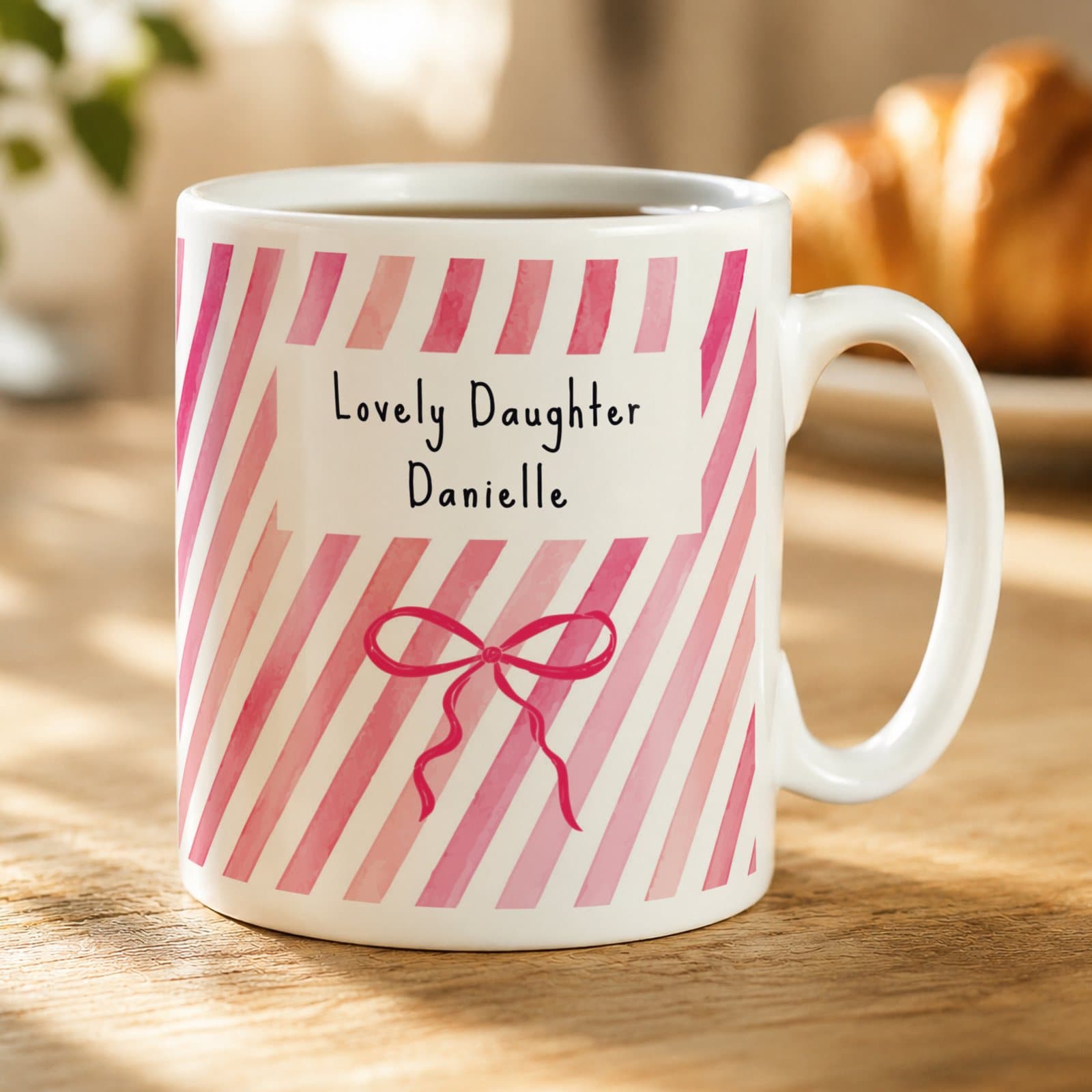Personalised ceramic mug with a pink striped bow design