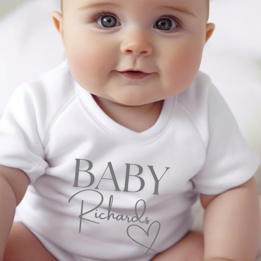 Personalised Surname Heart baby grow, vest or bib with a name printed on it