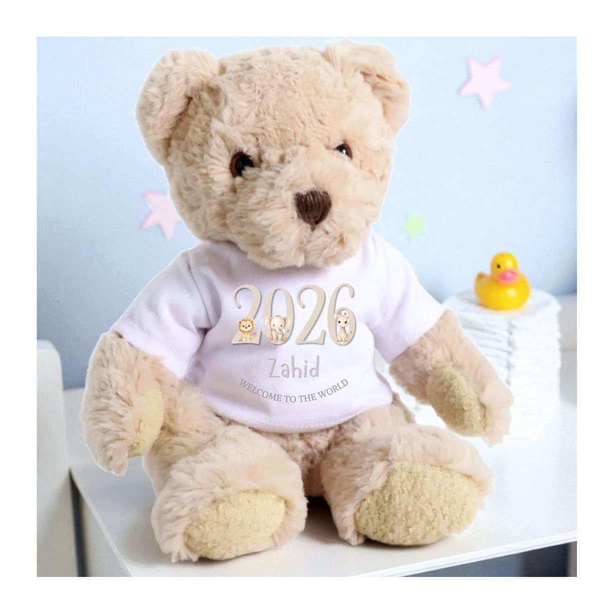 Taupe teddy bear in a jungle animal T-shirt with the wording 2026 Welcome to the World