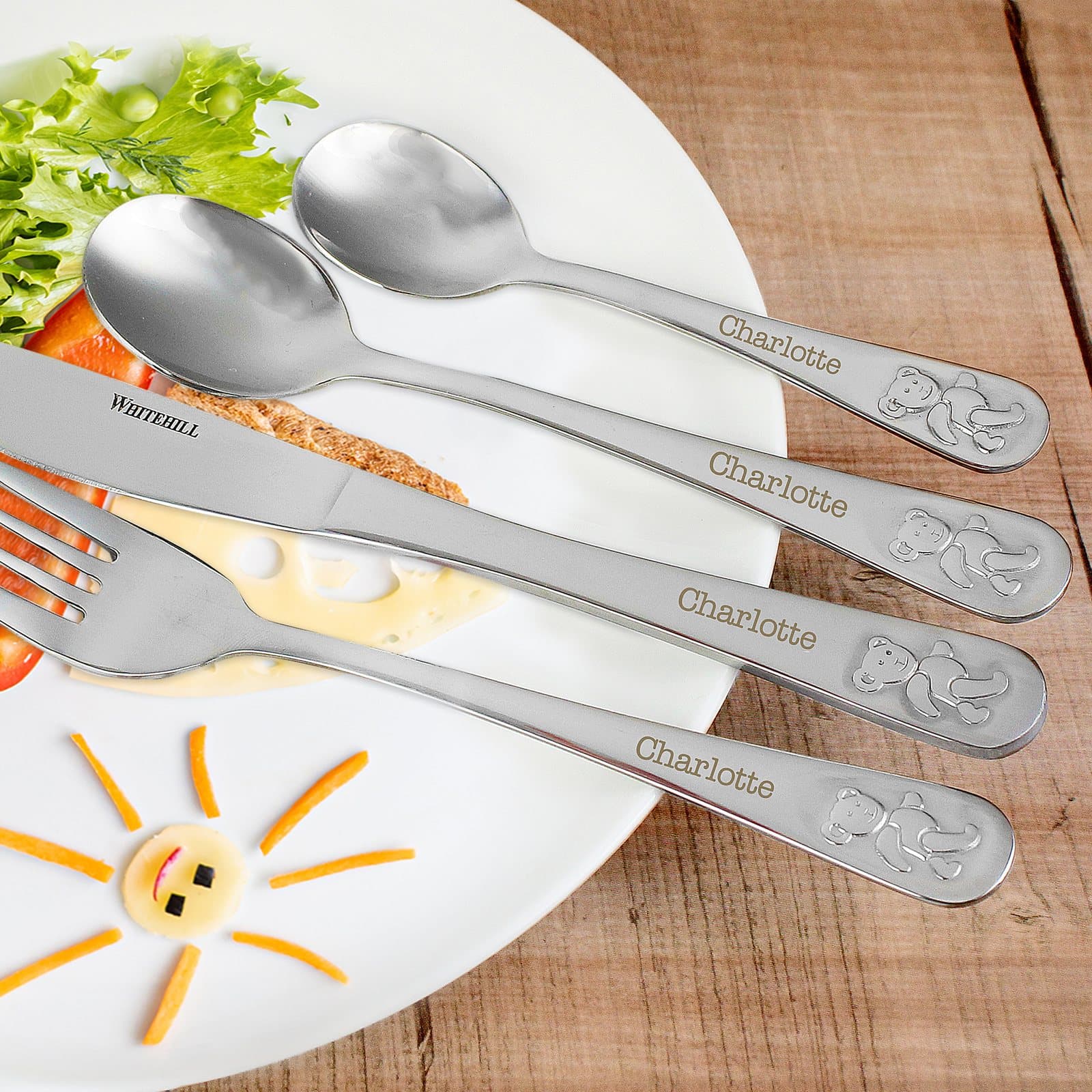 Four piece steel cutlery set with an embossed teddy design