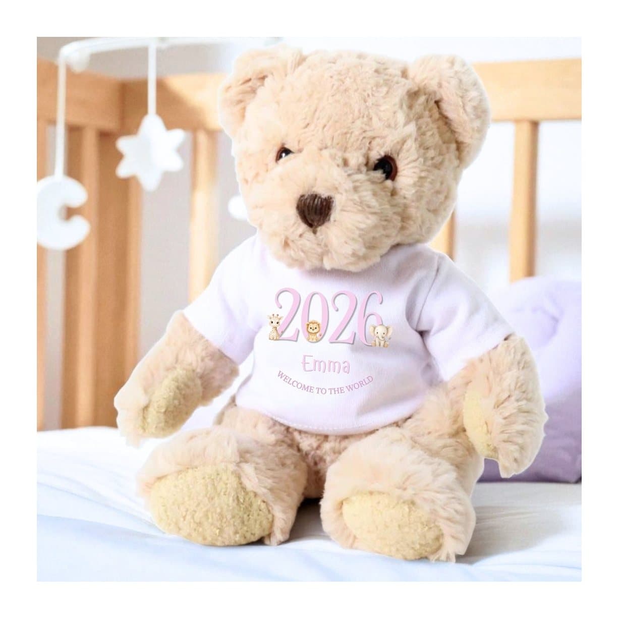 Teddy bear in a pink T-shirt with safari animals and Welcome to the World printed on it