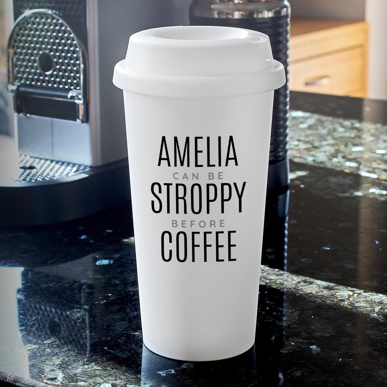Black plastic travel mug with a screw-on lid and a five-line text design