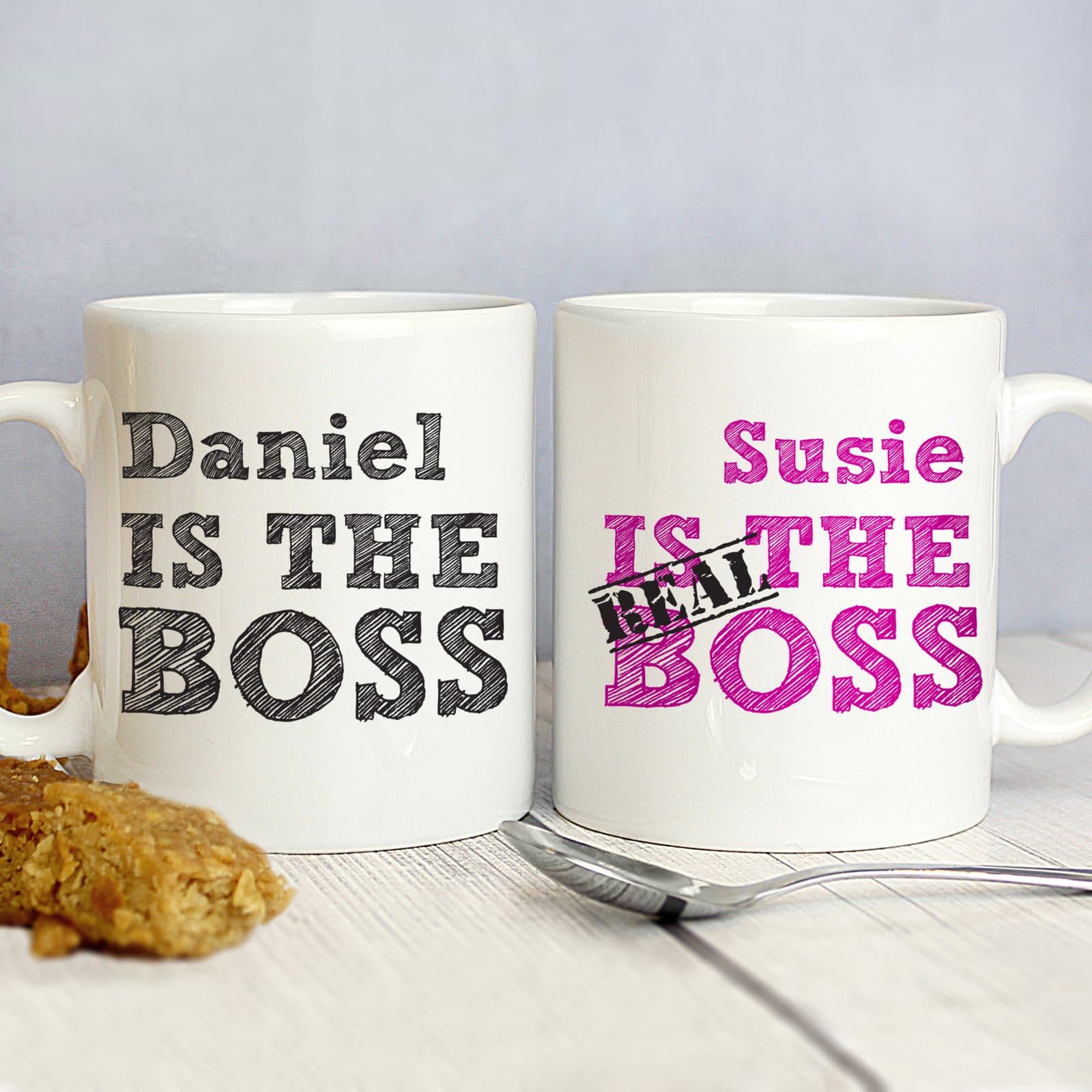 Personalised sketch mug set, one black mug and one pink mug with first names
