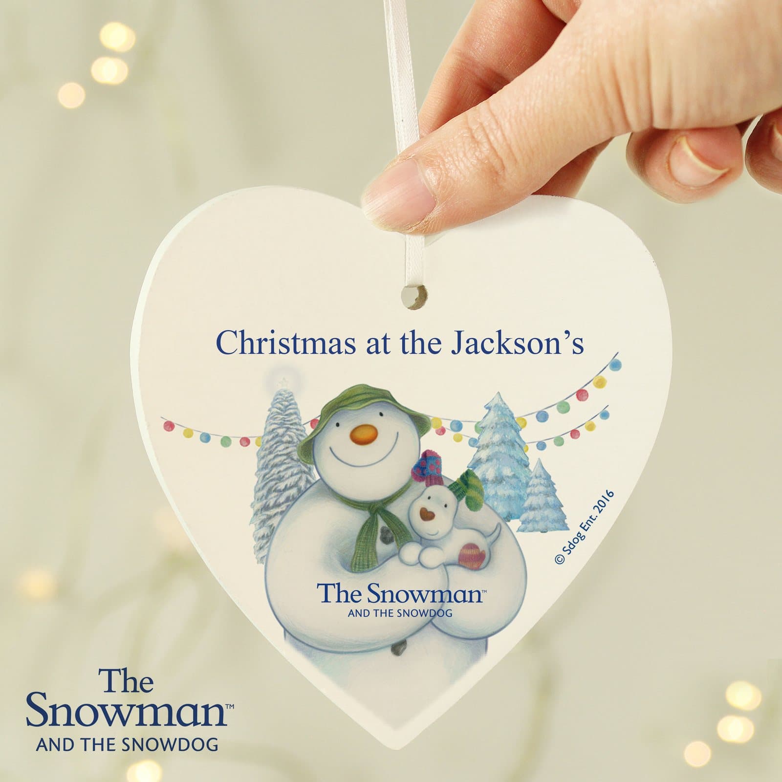 Wooden heart decoration with The Snowman and the Snowdog design and a line of text