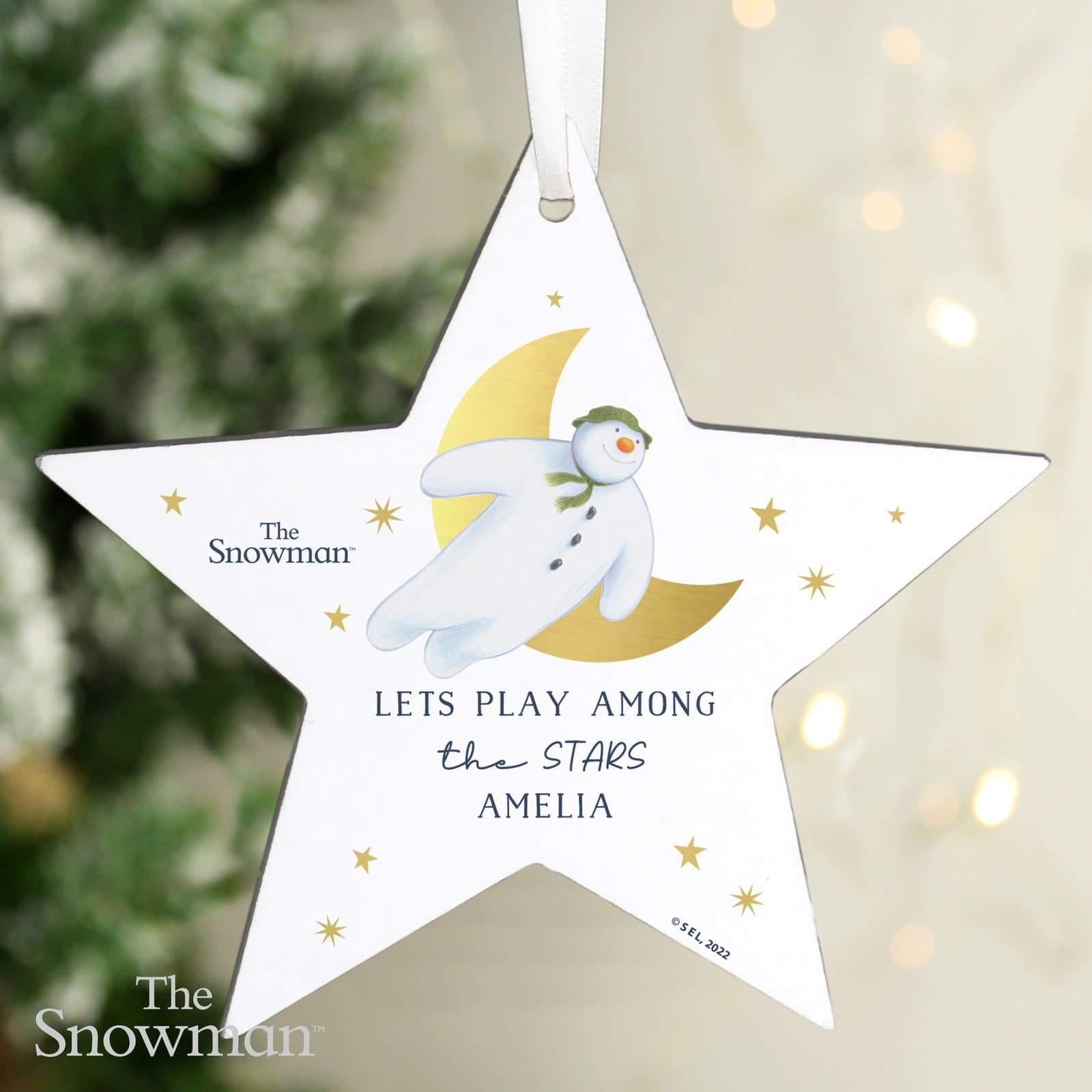 Wooden star decoration with The Snowman Gold Moon design and three lines of text