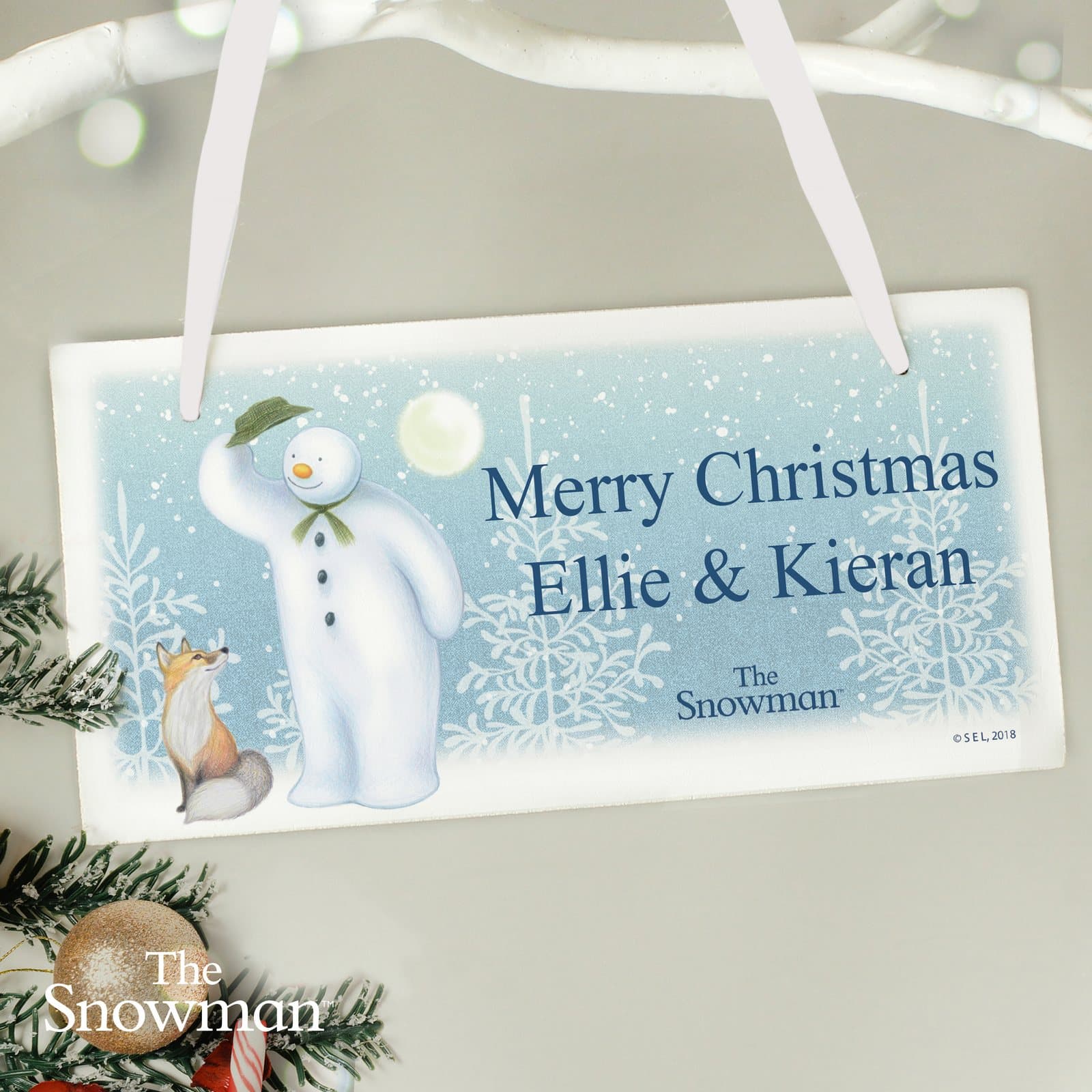 Rectangular wooden sign with The Snowman Snow Wonder design and two lines of text