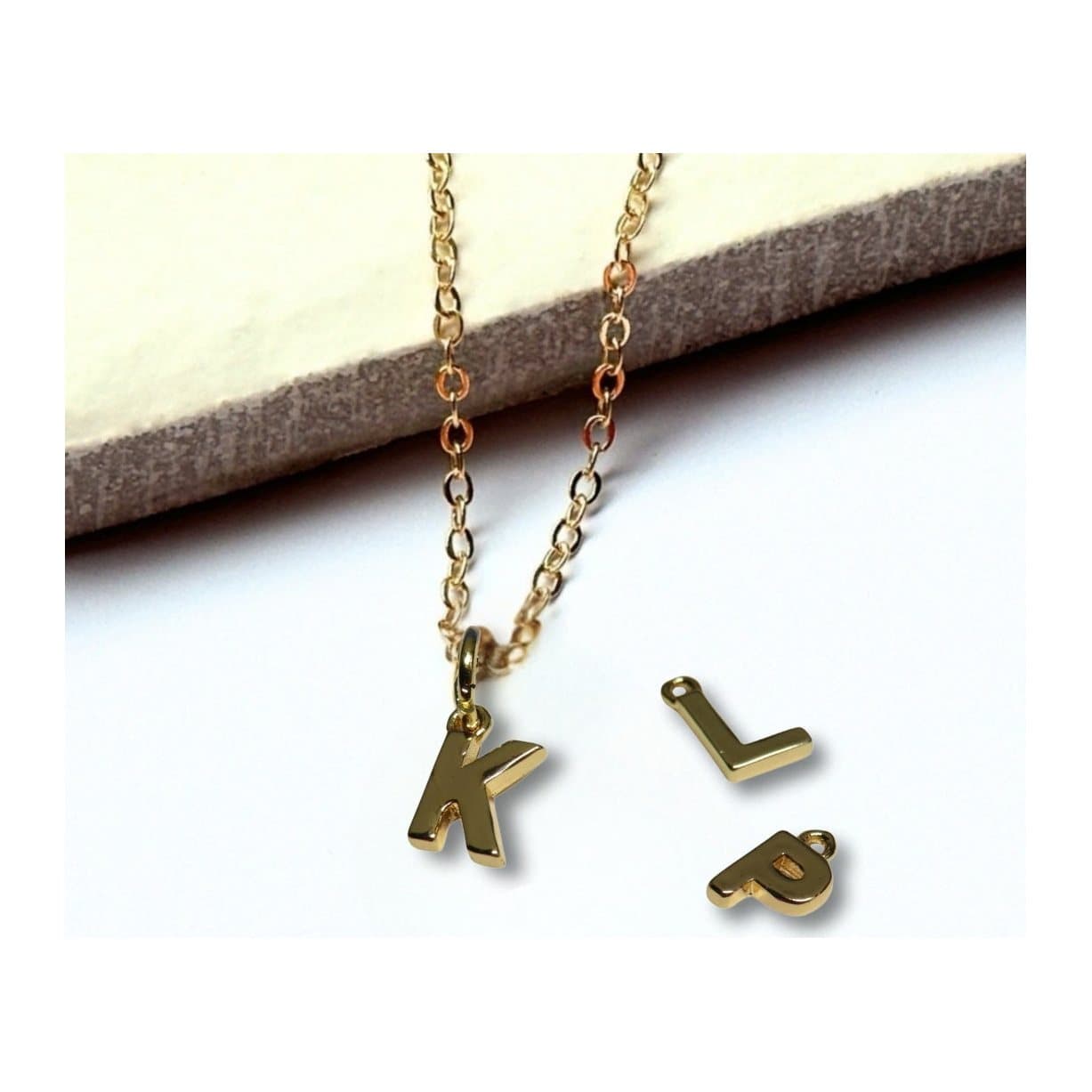 Personalised tiny gold initial necklace with a letter charm on an 18 inch chain