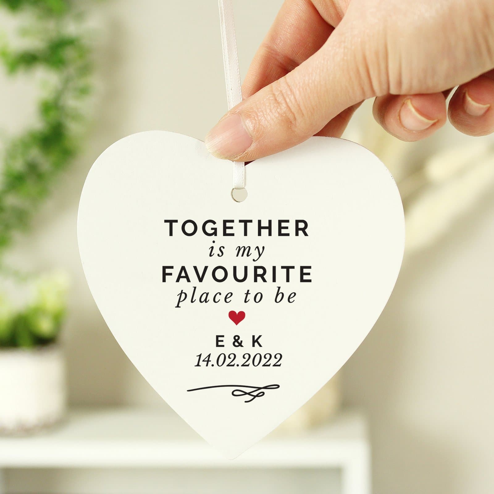 Wooden heart with Together Is My Favourite Place wording and a ribbon