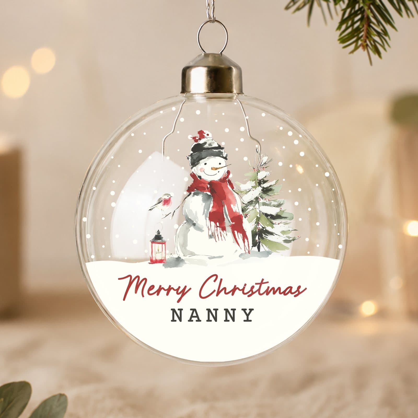 Glass bauble with a snowman scene and ribbon