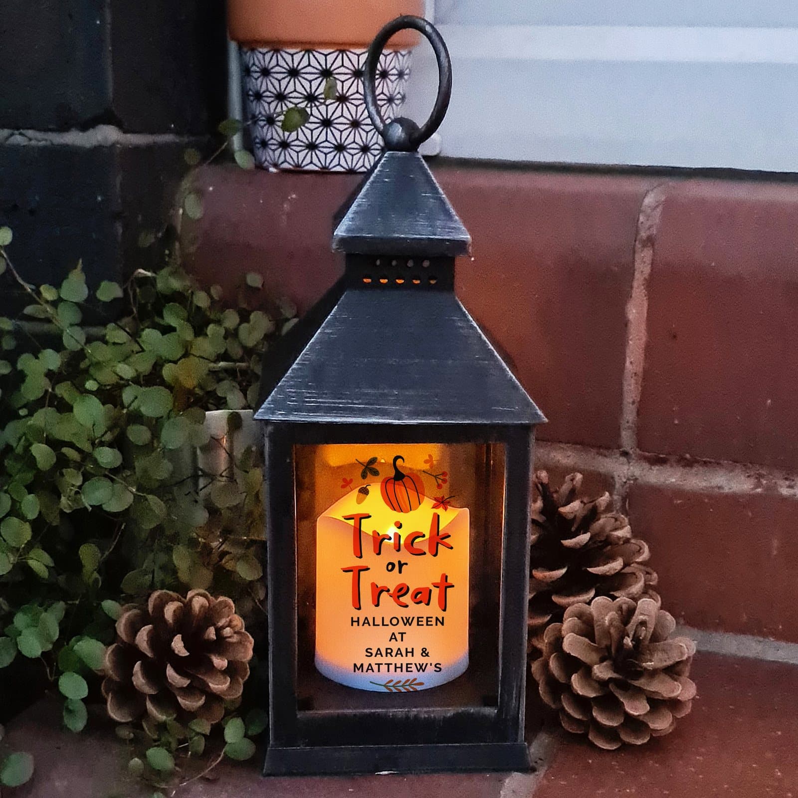 Matt plastic Halloween lantern with trick or treat text and a warm orange flame effect