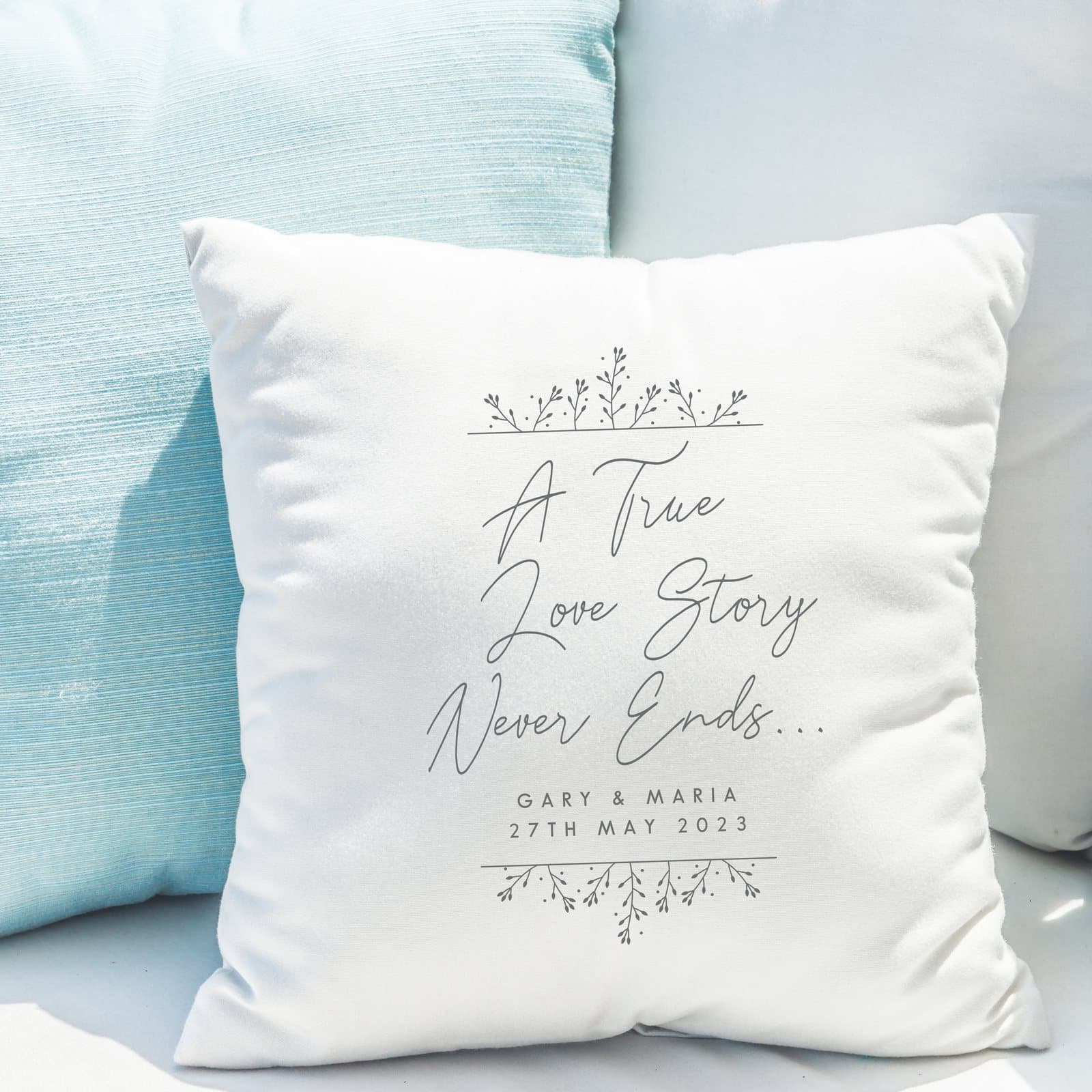 White cushion with the phrase A True Love Story Never Ends and a message