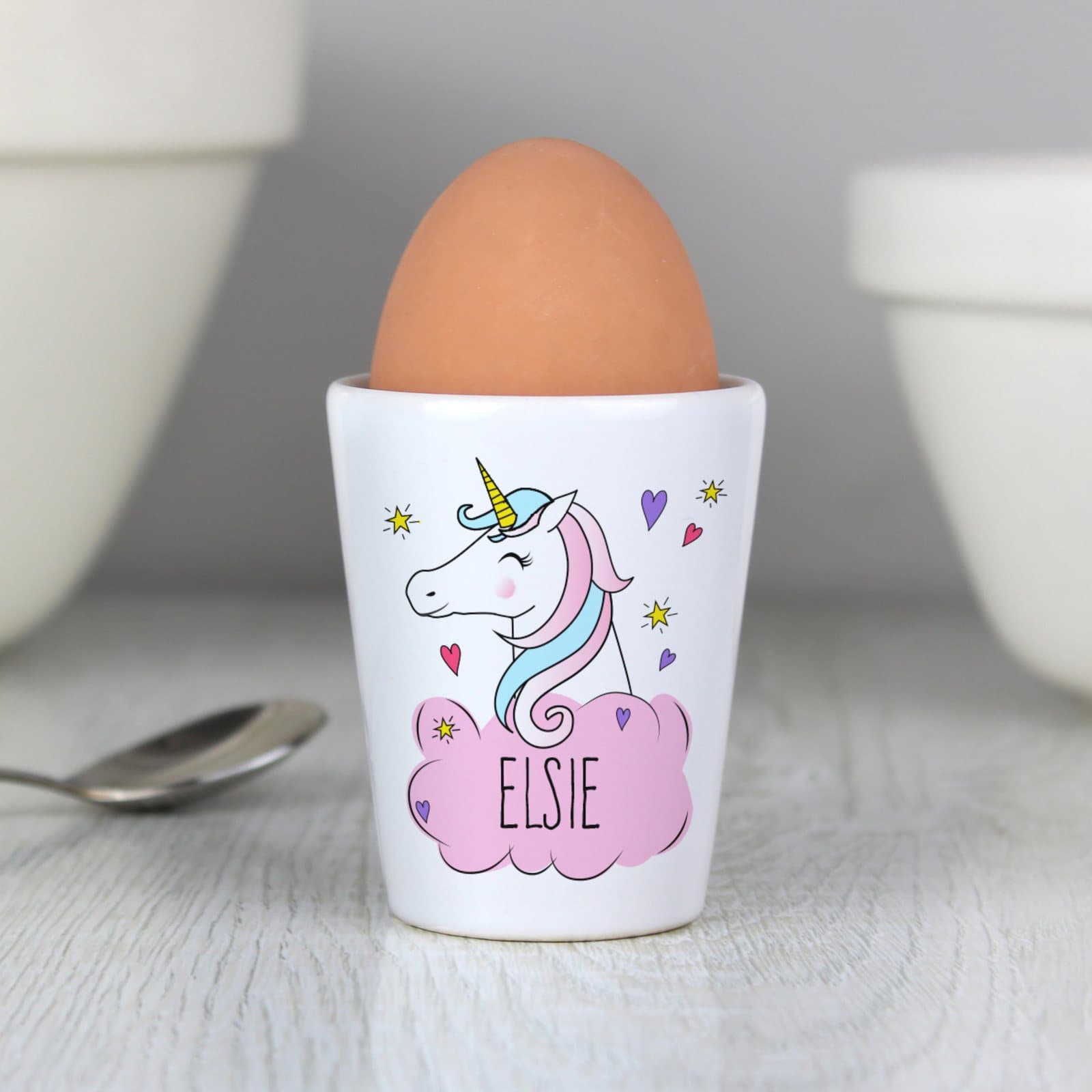 Personalised ceramic unicorn egg cup with a name