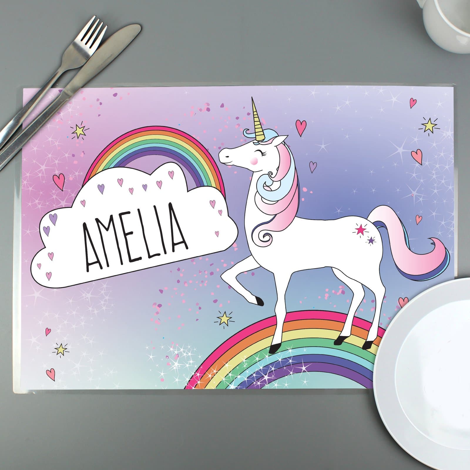 Laminated unicorn placemat with a child's name printed in capitals