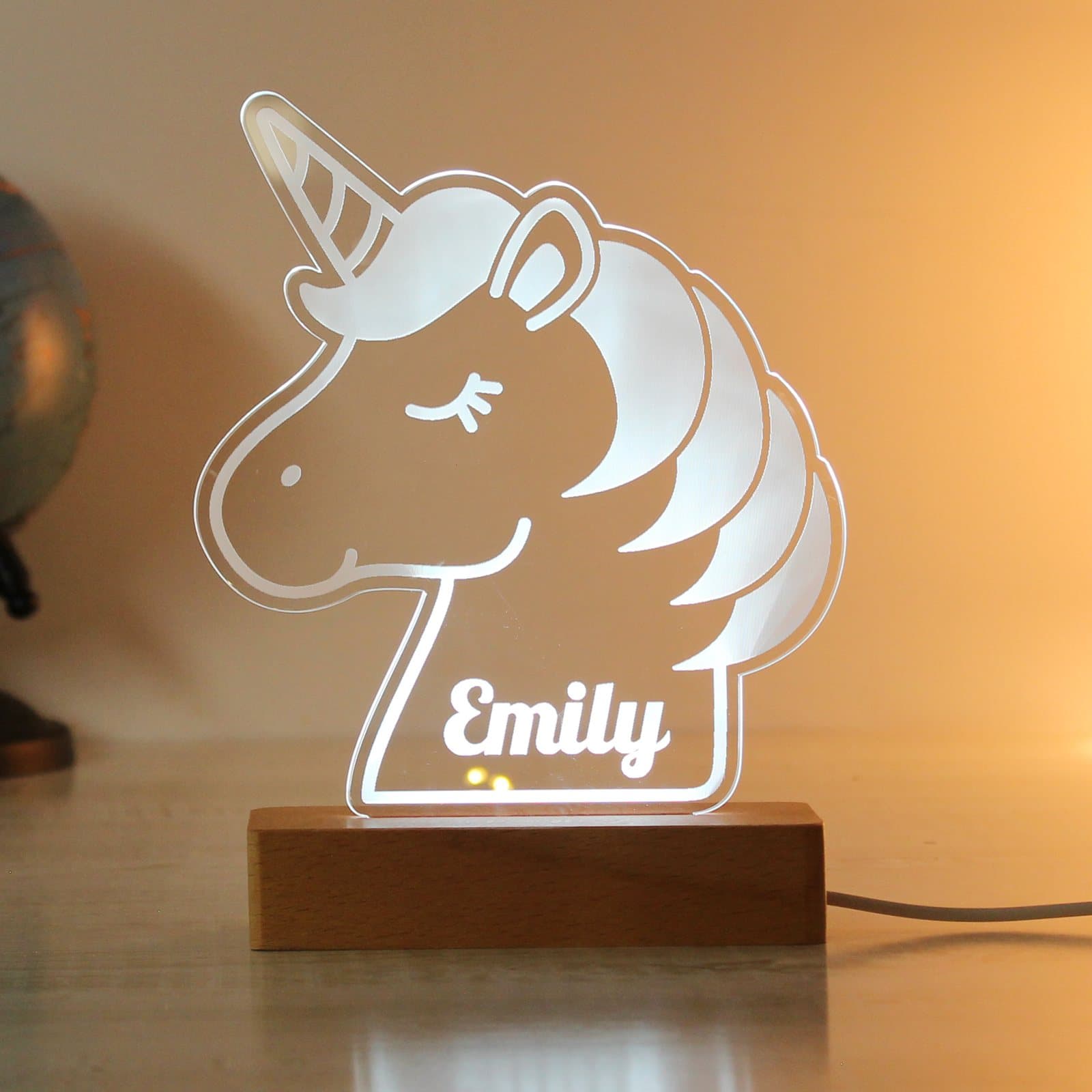 Unicorn LED light sign on a wooden base
