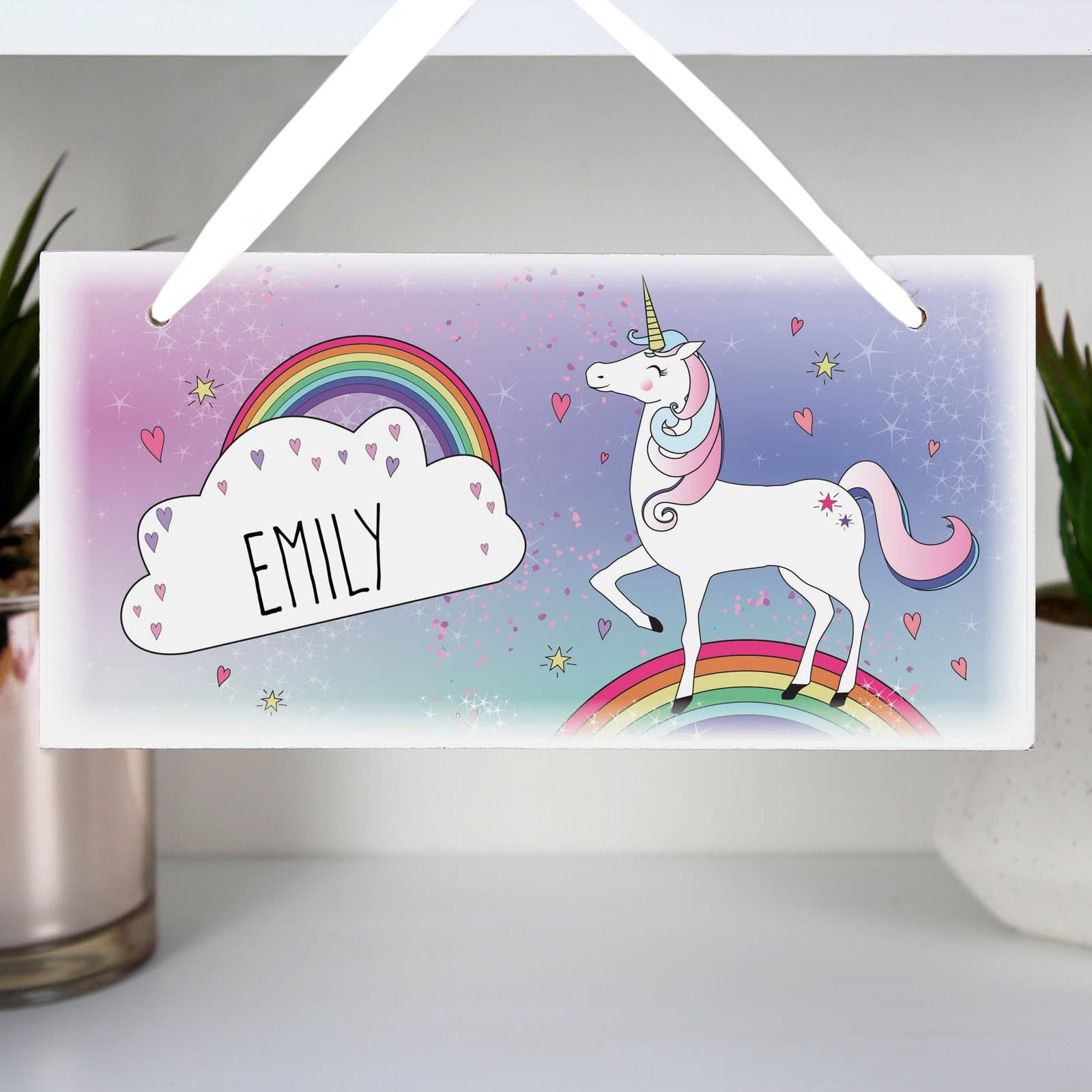 Wooden unicorn sign with a ribbon and a name in capital letters