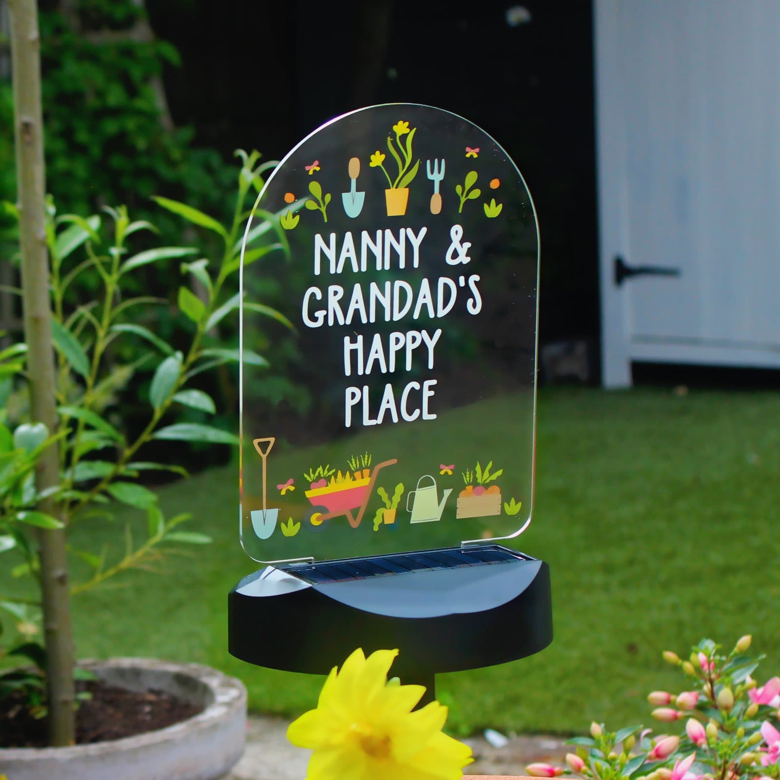 Solar garden light with a personalised sign on a ground stick