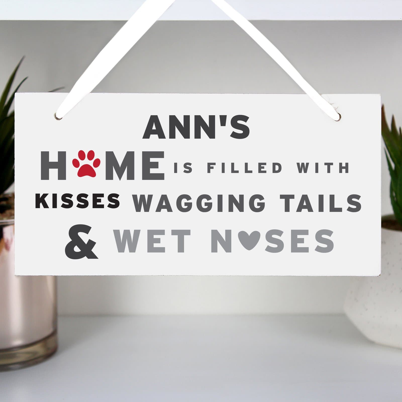 Wooden dog sign with a name and the words about kisses, wagging tails and wet noses