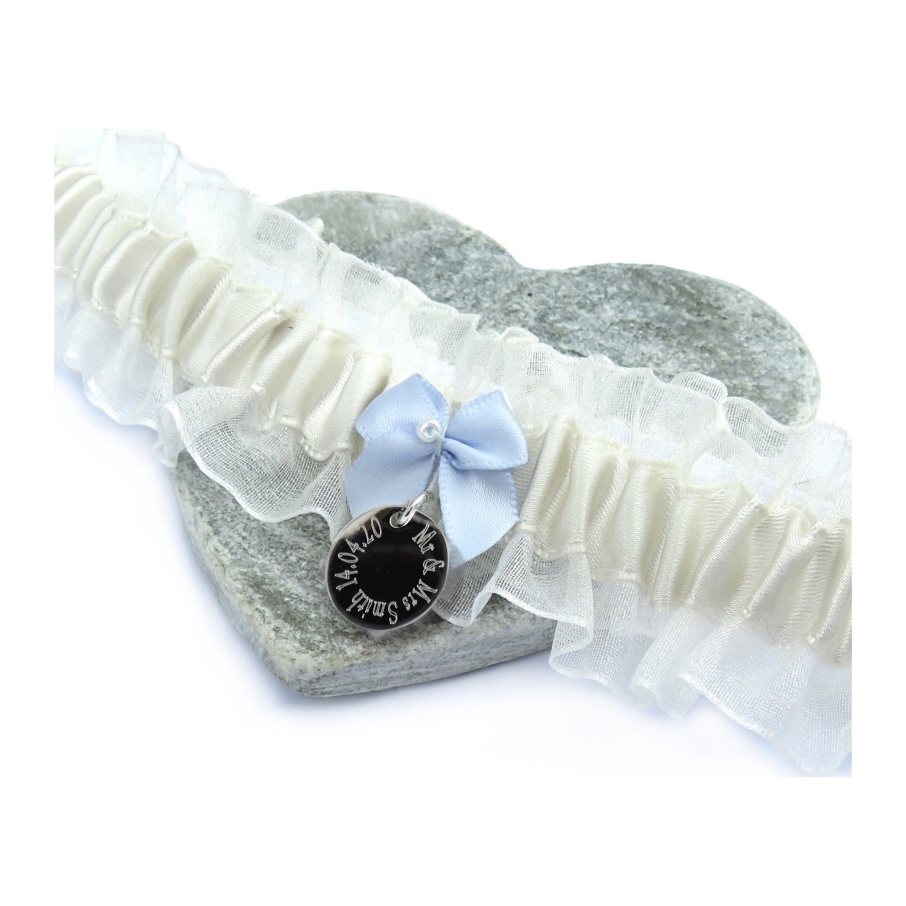 Personalised wedding garter in ivory satin with a blue bow and a silver charm
