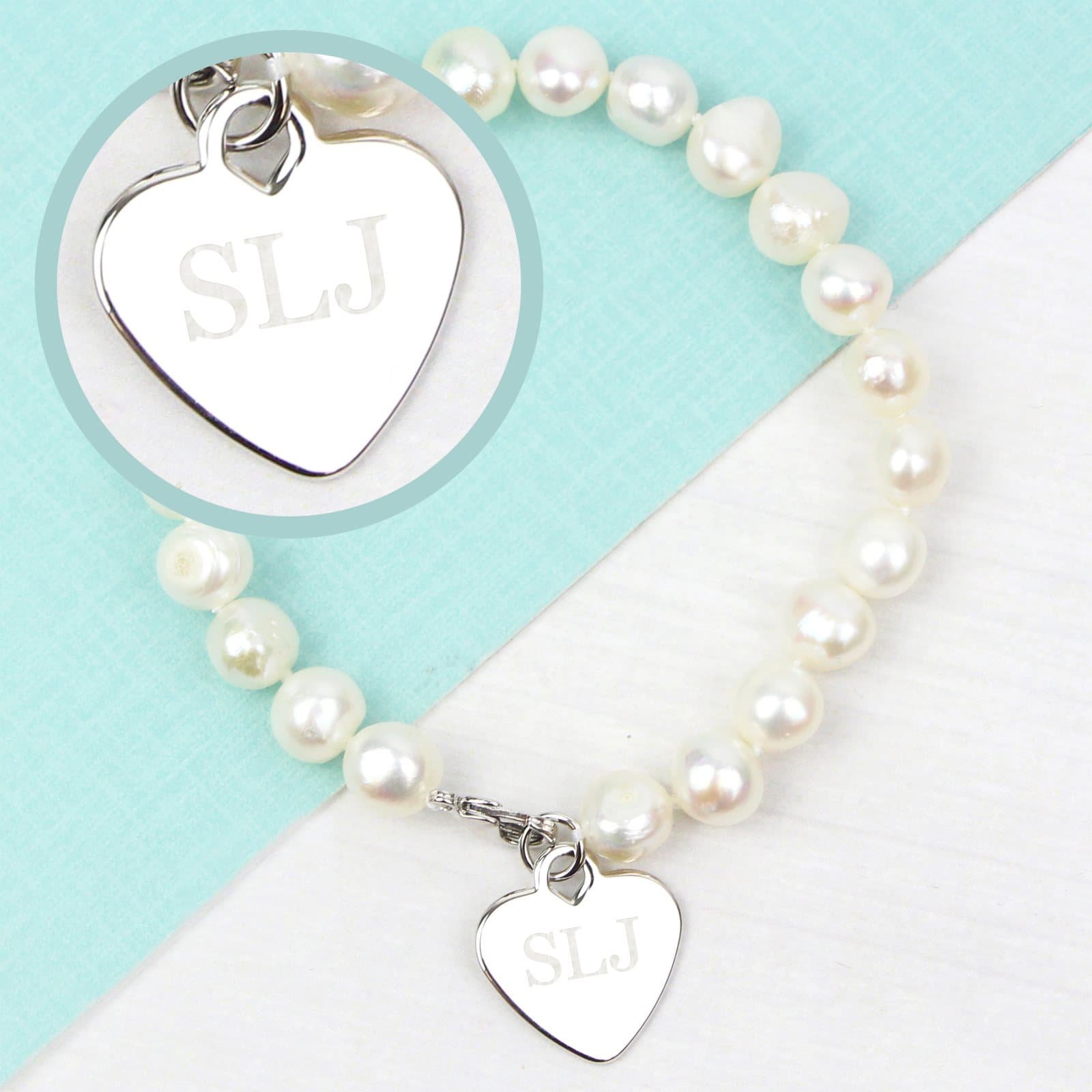 White freshwater pearl bracelet with a rhodium plated heart tag