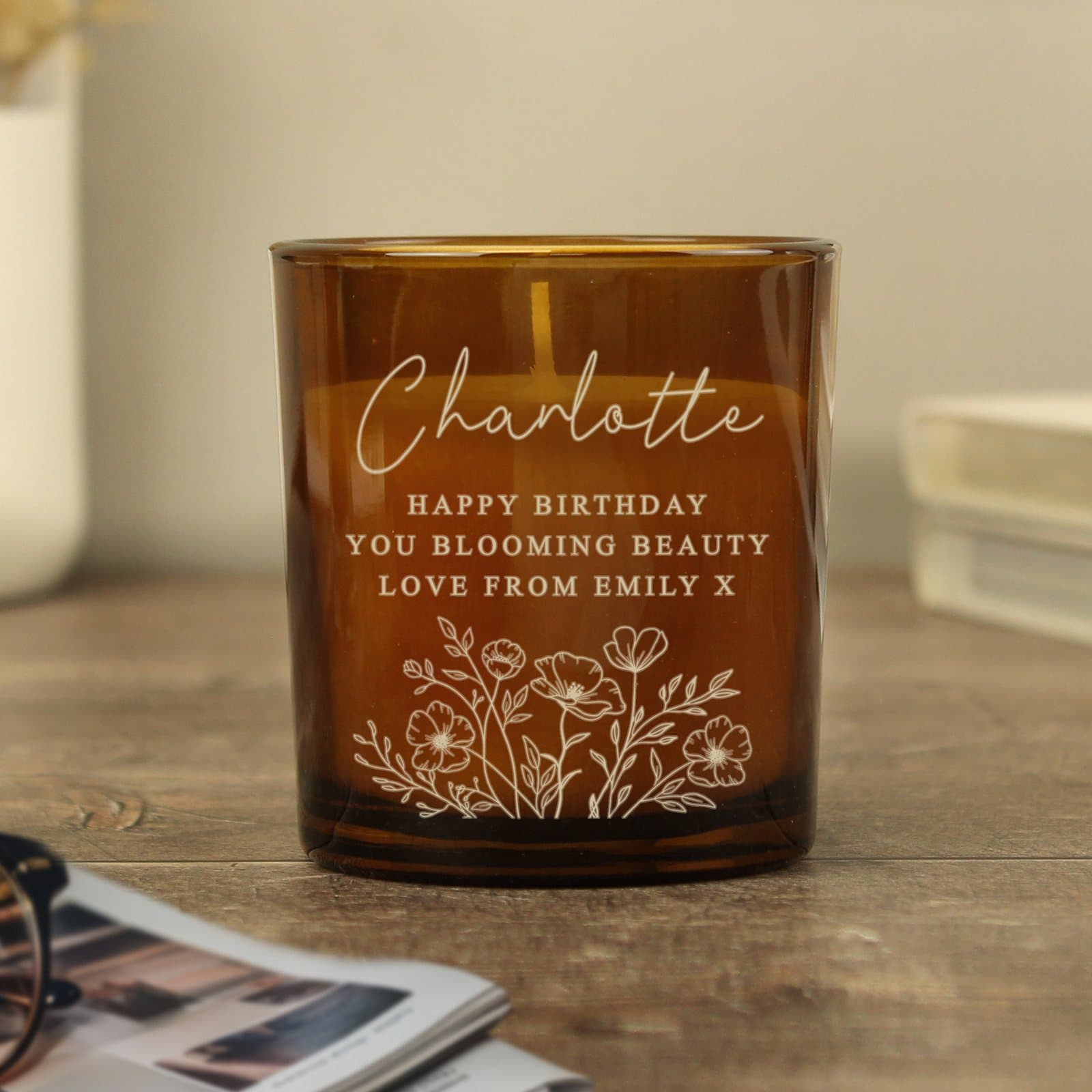 Amber glass candle jar with a wild flowers design and personalised name