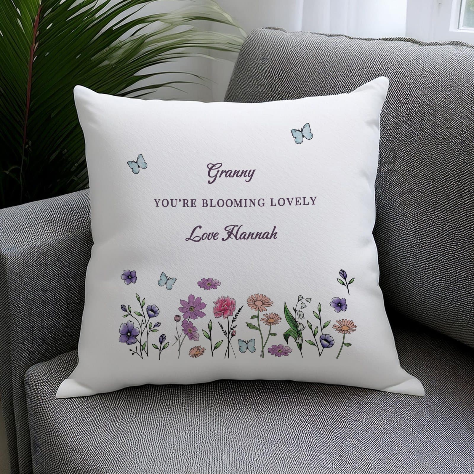 Cushion with a design of delicate wildflowers and personalised text