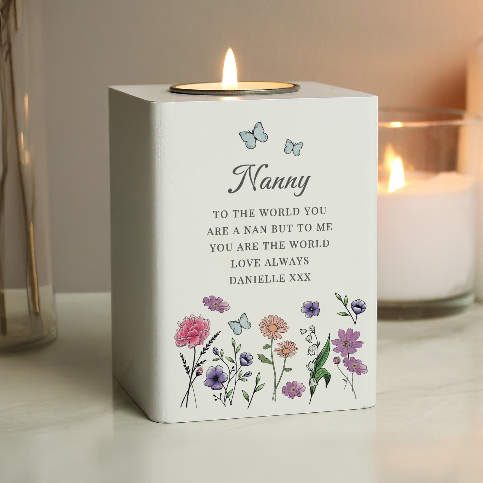 Soft white wooden tealight holder with an engraved wildflower design