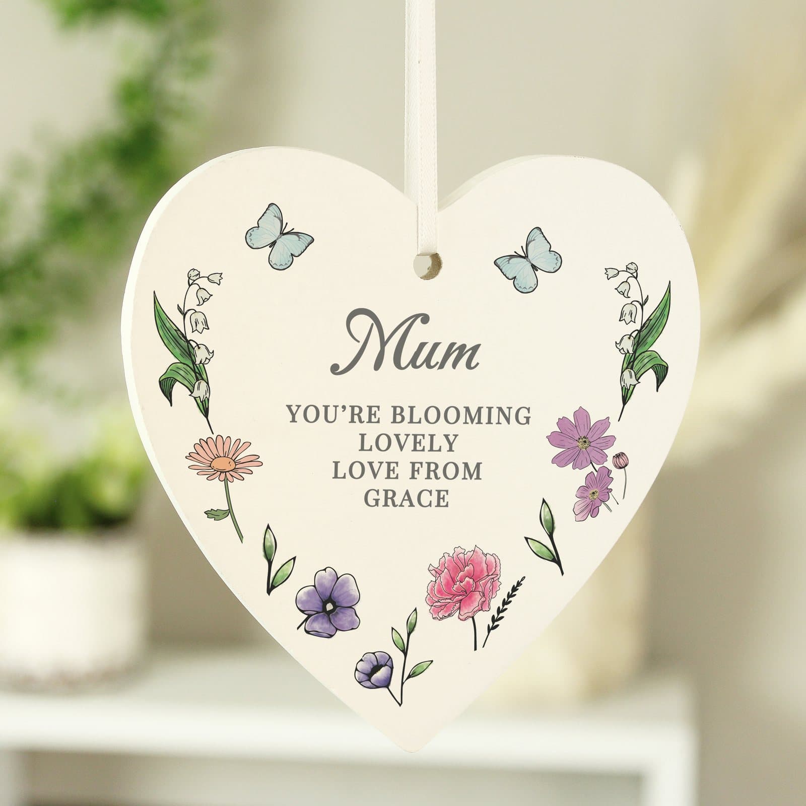 Wooden heart decoration with wildflower illustrations and ribbon