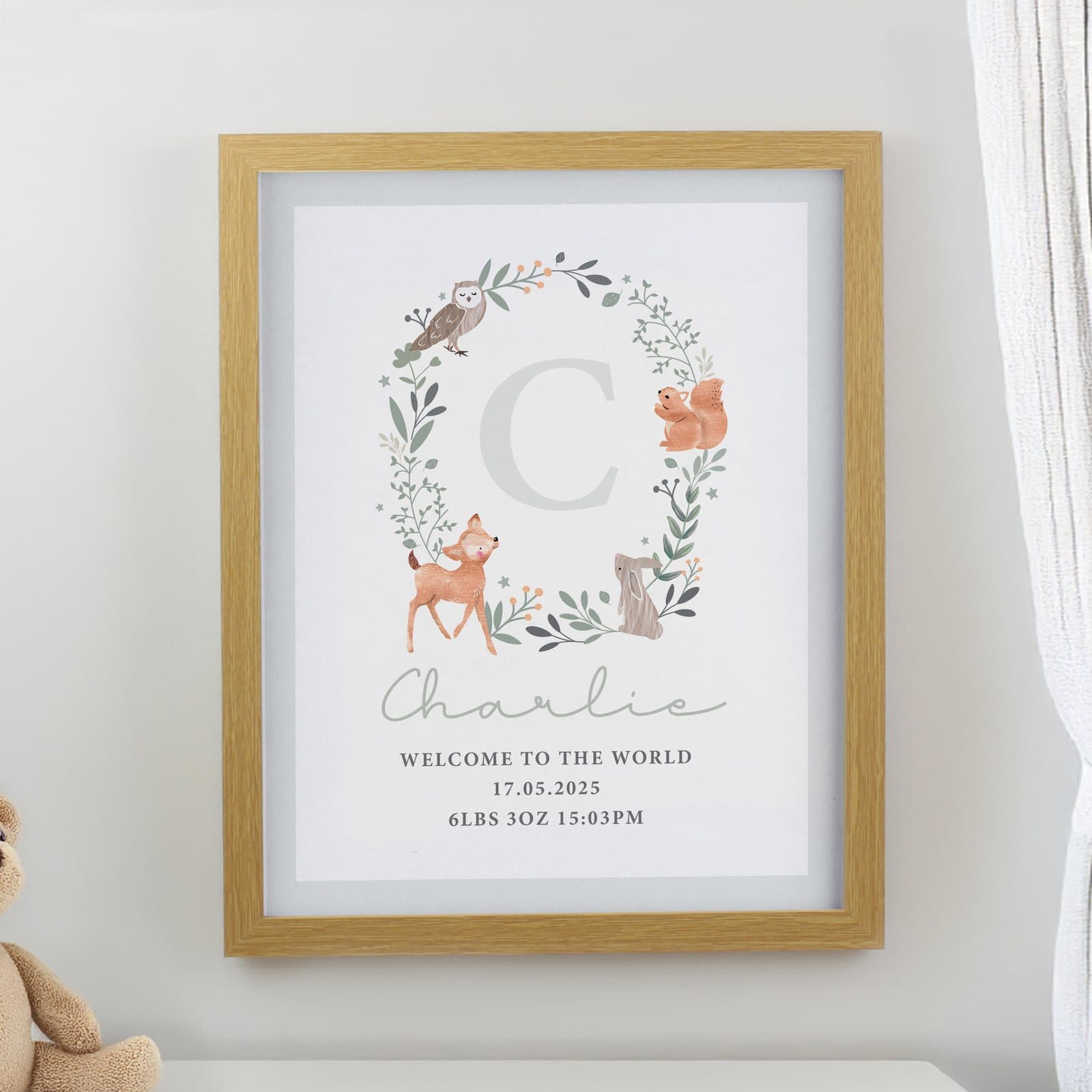 Oak frame with a woodland animal print, a name and an initial