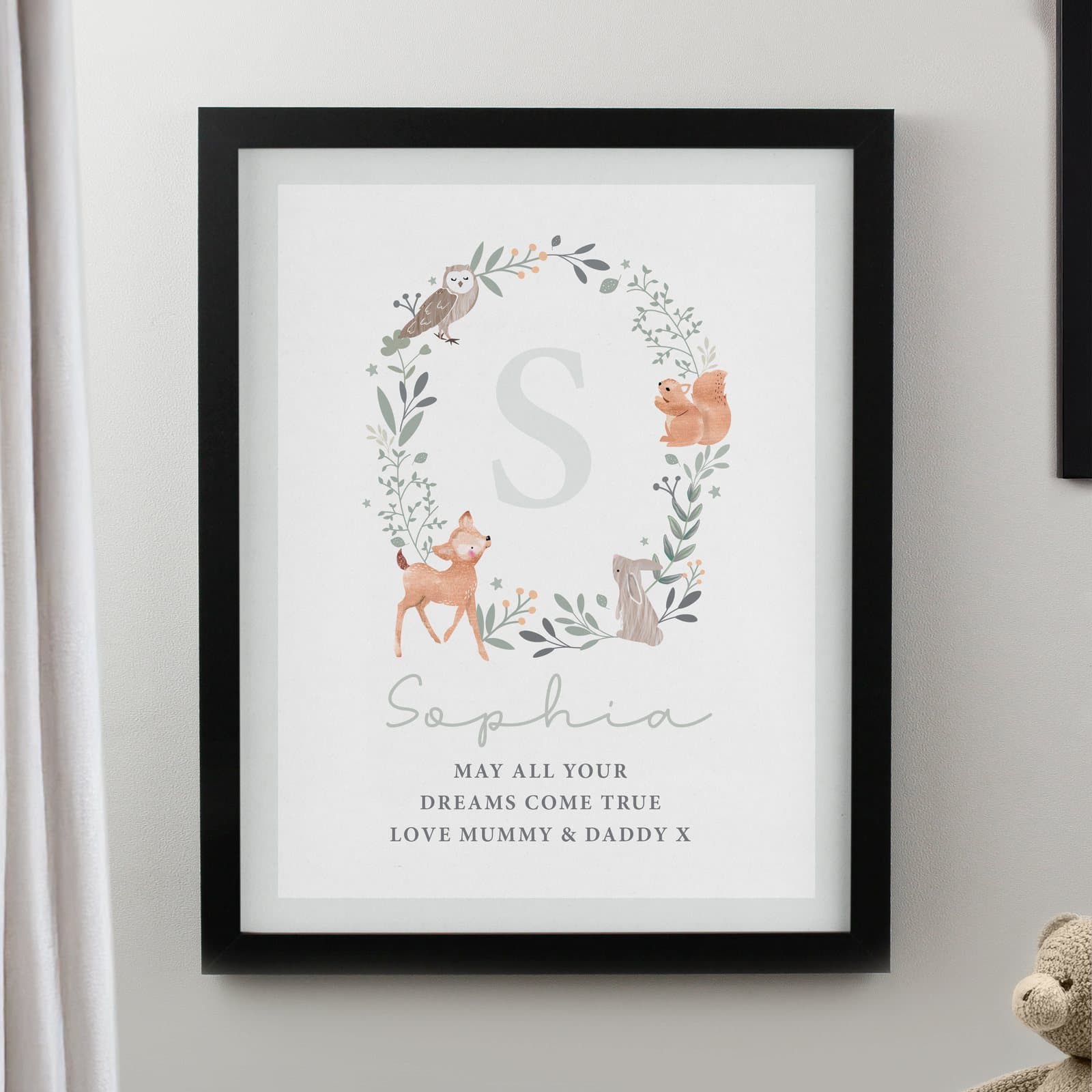 Woodland animal print in a poster frame with a name and an initial