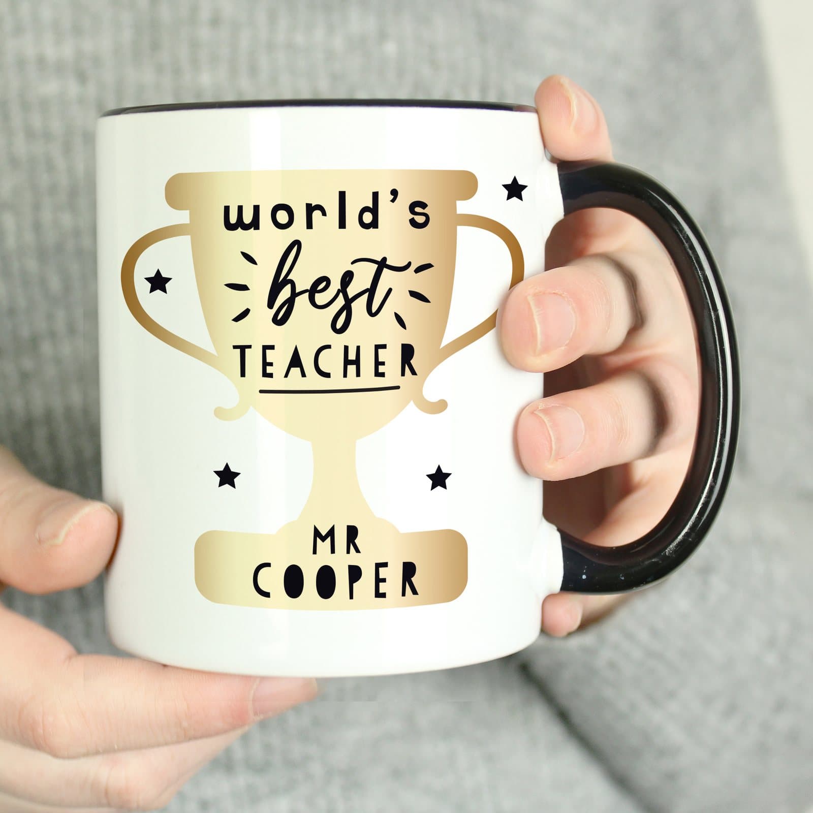 Black handled World's Best Teacher trophy mug
