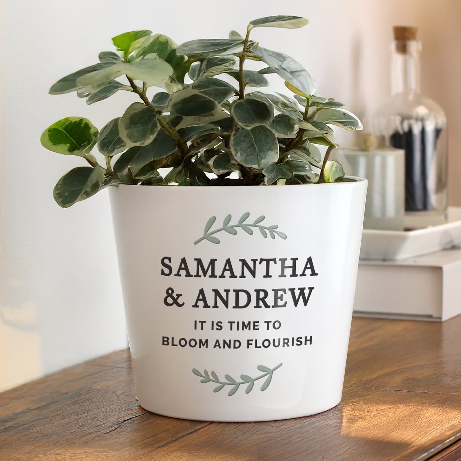 Personalised large ceramic plant pot with a wreath design and four lines of text