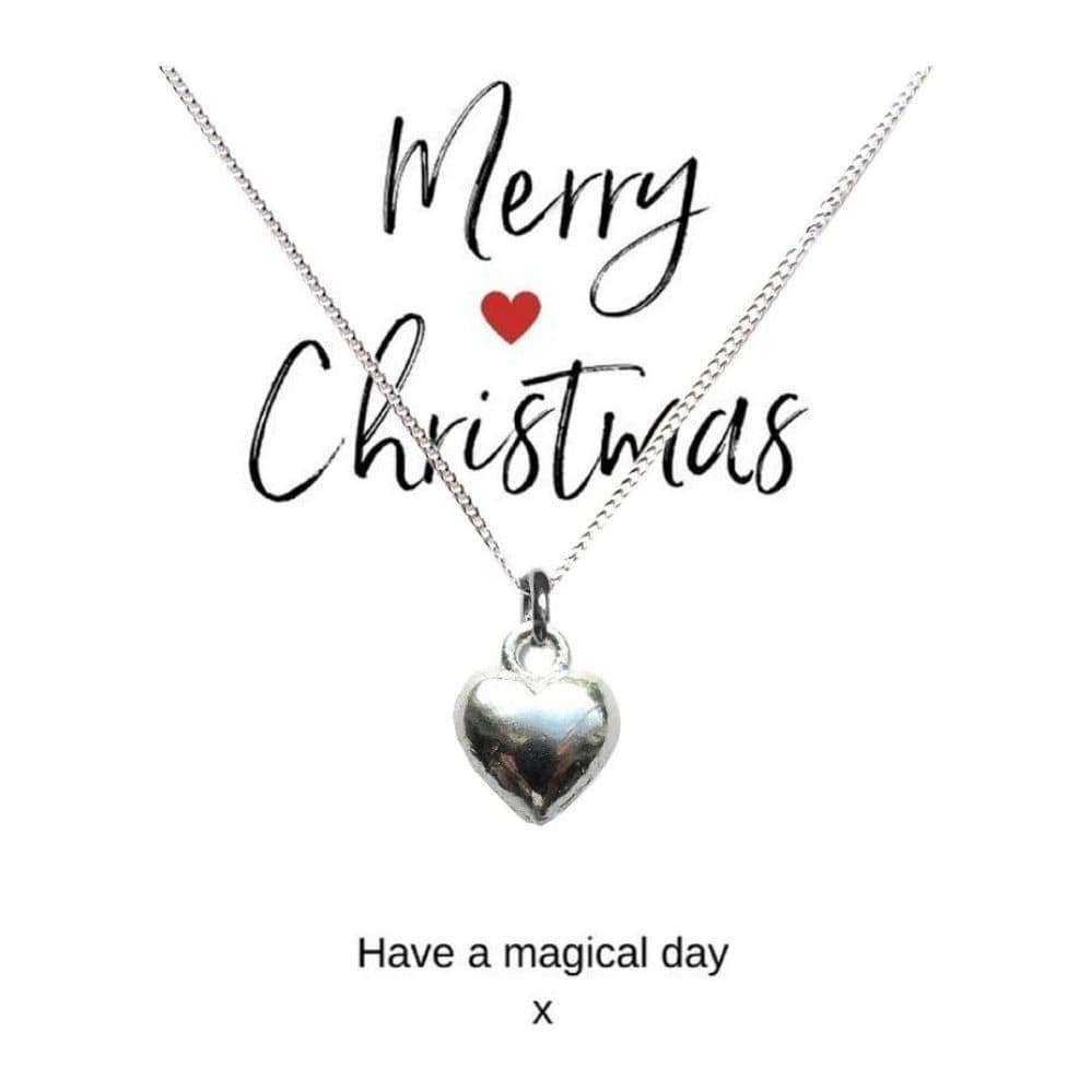 Silver puff heart necklace on a Merry Christmas card